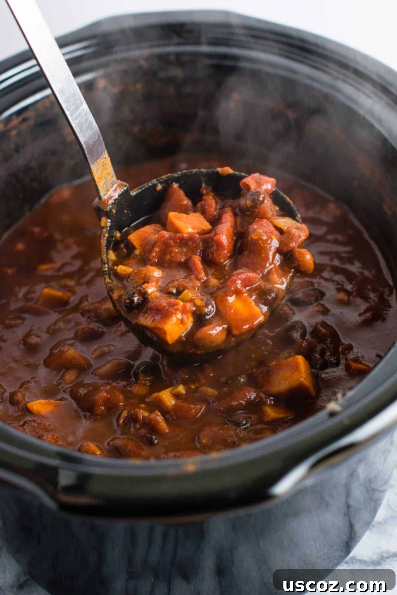 Easy Slow Cooker Vegetarian Sweet Potato Chili 3 Close-up of a bowl of slow cooker vegetarian sweet potato chili, showing the rich texture and colorful ingredients.