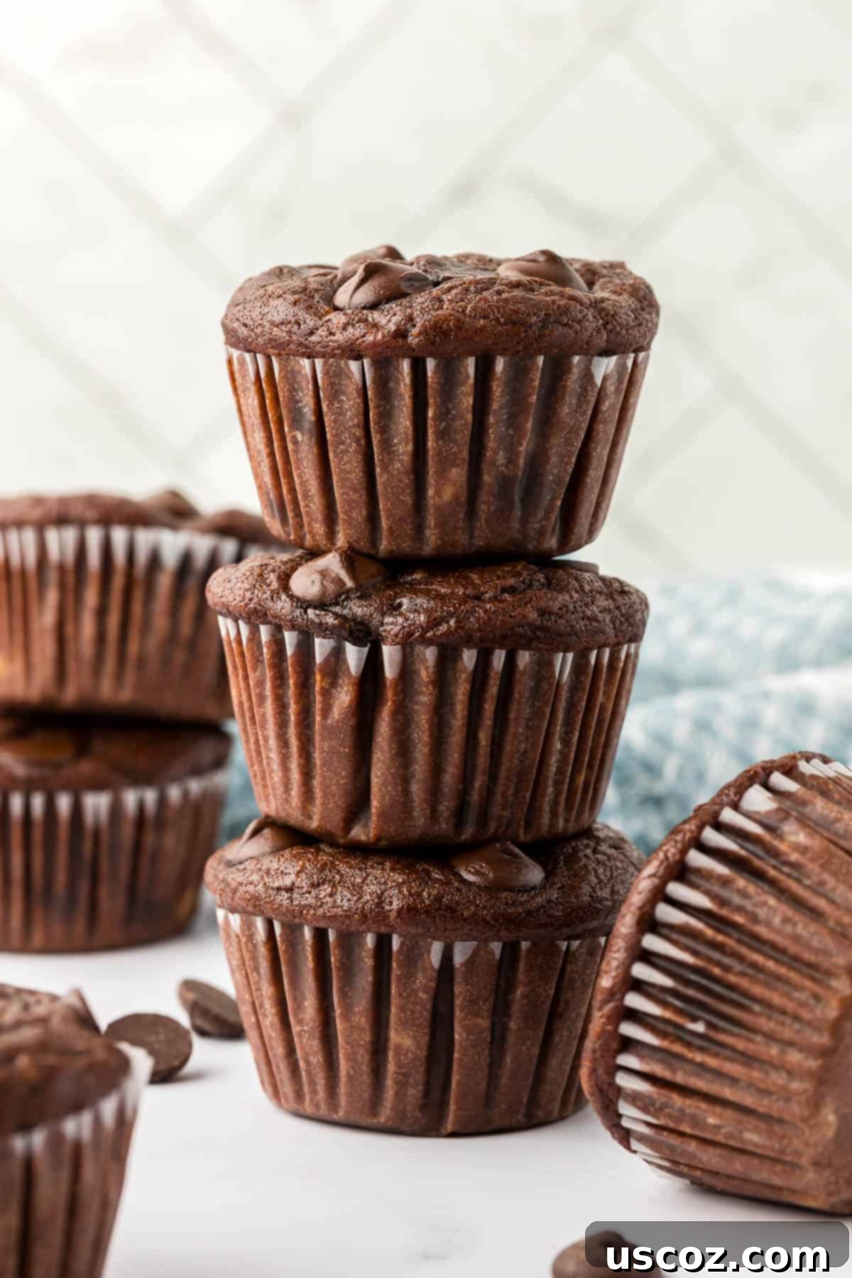 Nourishing Chocolate Muffins 2 healthy chocolate muffins stacked on a plate