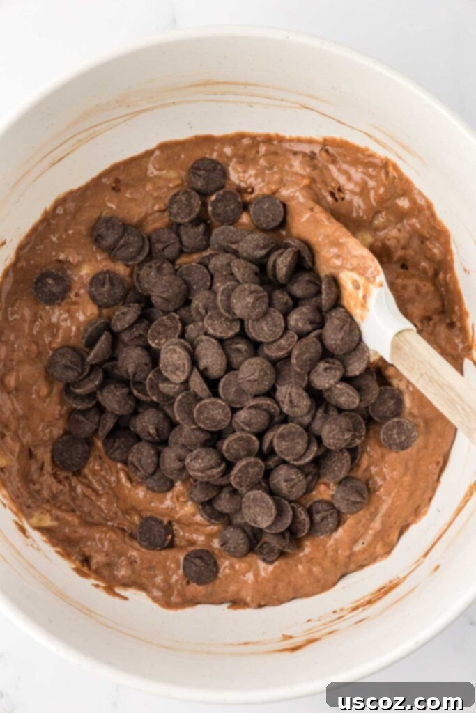 Nourishing Chocolate Muffins 11 Adding chocolate chips to muffin batter