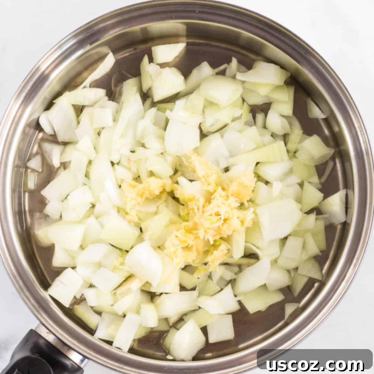 Garden Harvest Pie 4 Diced onion and minced garlic are sauteing in a skillet with olive oil, starting to soften and release their aromatic flavors.