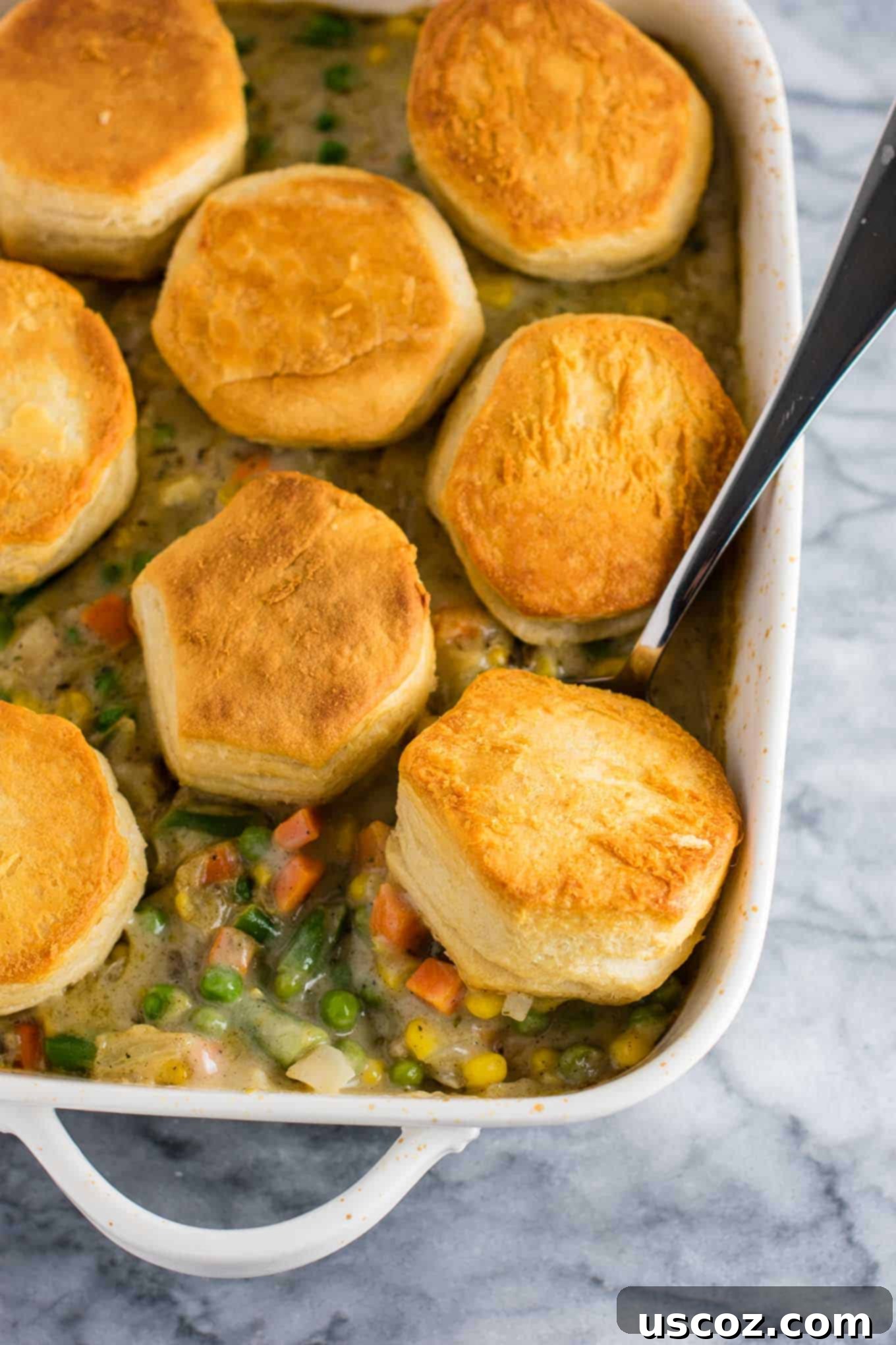 Garden Harvest Pie 10 A deconstructed veggie pot pie recipe with flaky biscuits on top, served in a casserole dish.