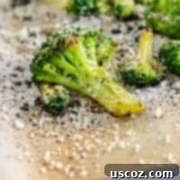 Perfectly Roasted Frozen Broccoli 10 Crispy roasted frozen broccoli on parchment paper, ready to be served.
