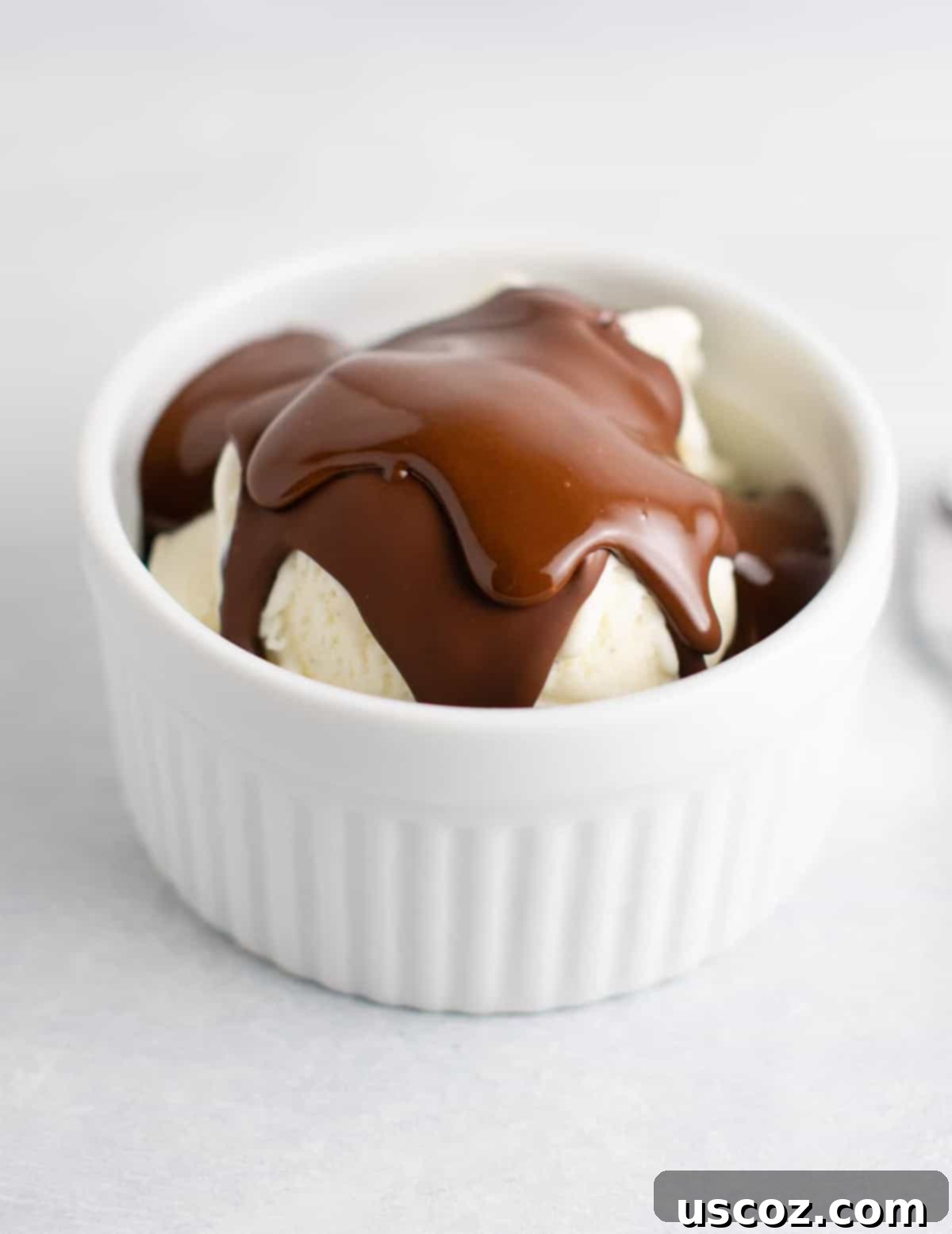 Easy homemade magic shell made with just 3 ingredients hardening on ice cream. Perfect for a special treat.