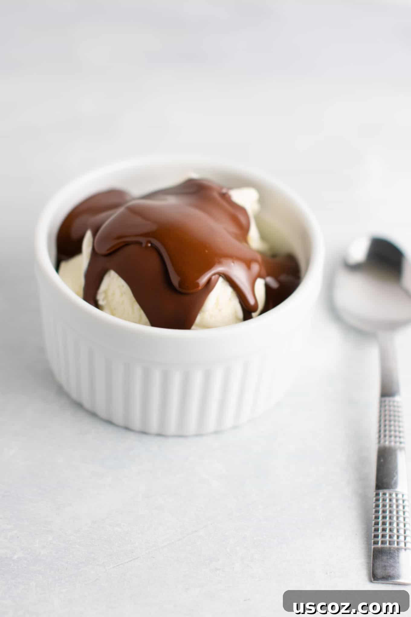 Homemade chocolate peanut butter shell hardening on ice cream. Made with only 3 ingredients.