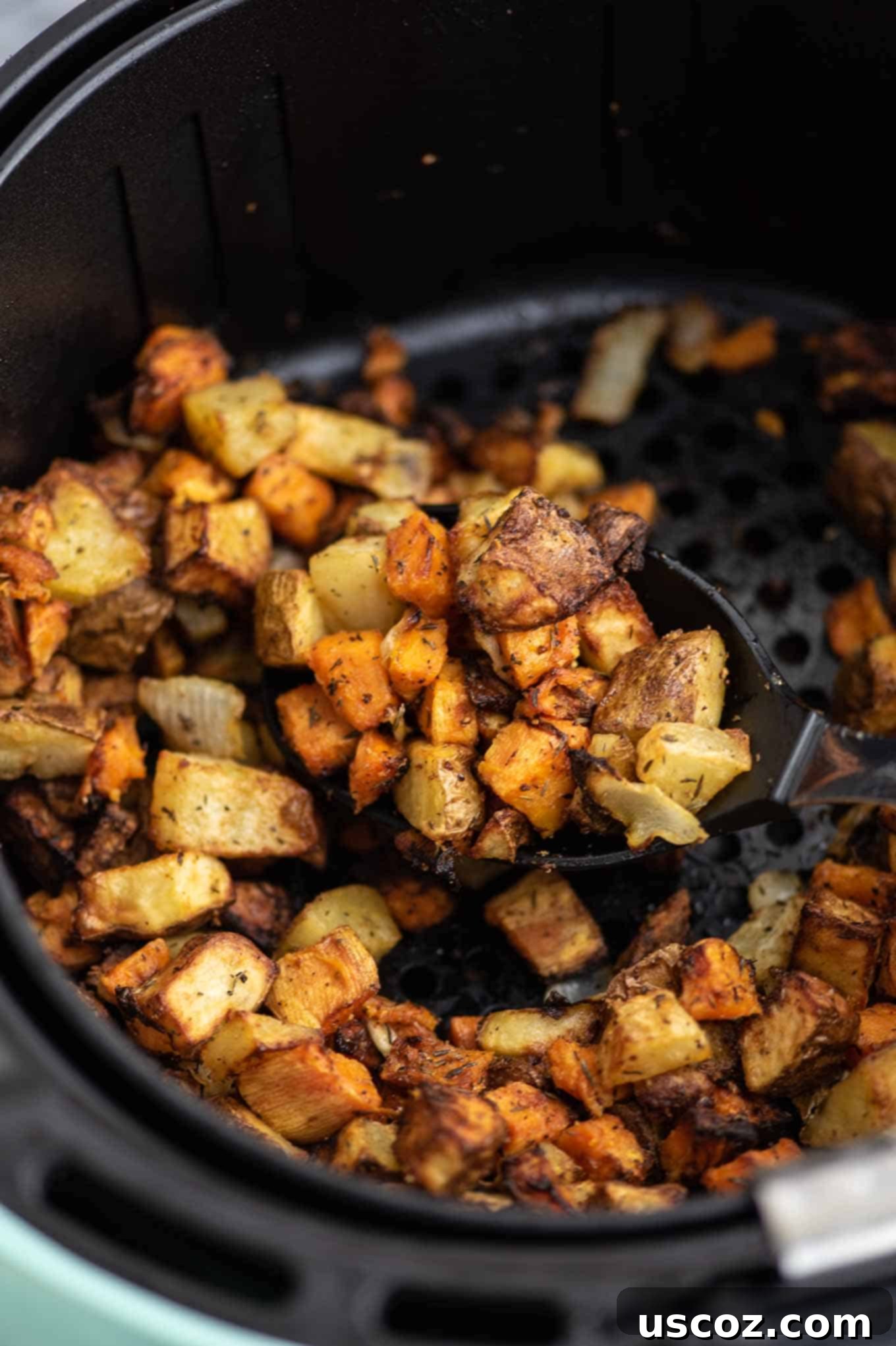 Your New Favorite Breakfast Burrito 7 A close-up of air fryer breakfast hash with sweet and russet potatoes, herbs, and spices