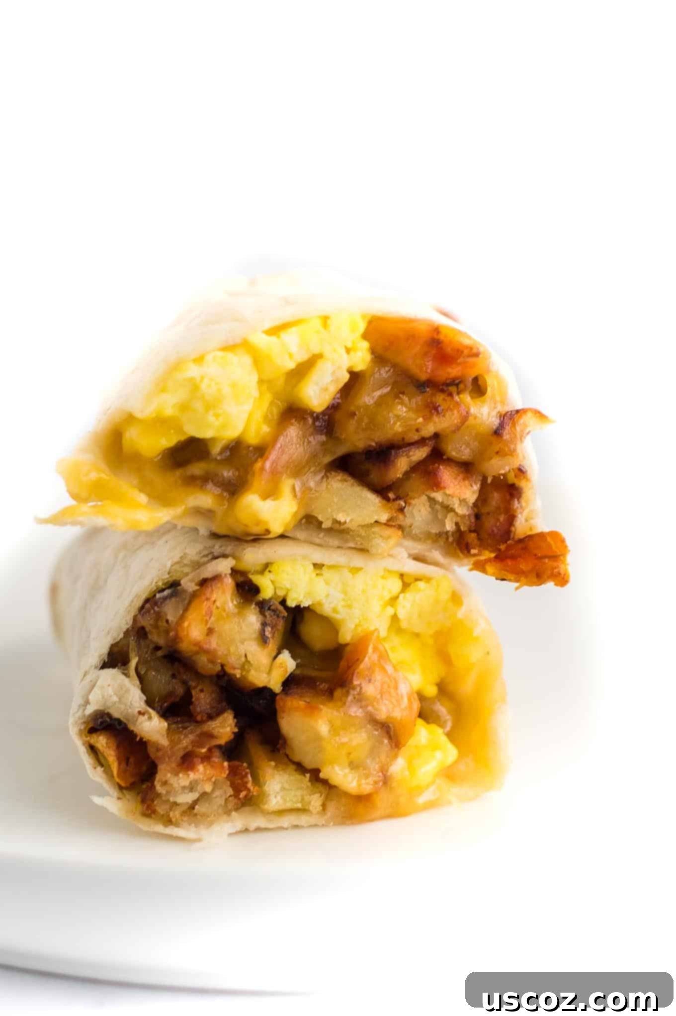 Your New Favorite Breakfast Burrito 8 Two neatly cut breakfast burritos, stacked and ready to serve