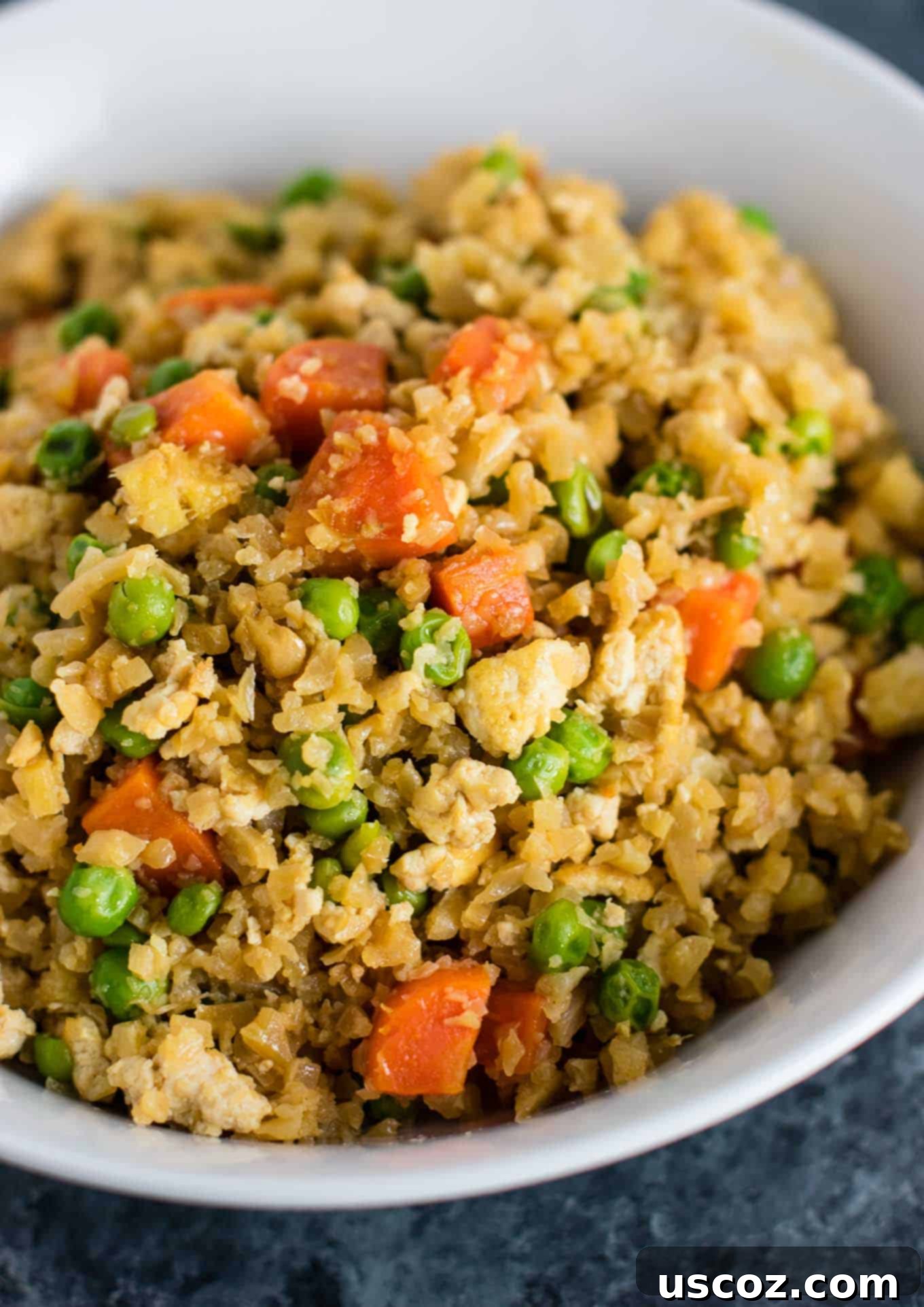 Wholesome Cauliflower Tofu Fried Rice 11 A generous serving of healthy vegan cauliflower tofu fried rice, showing its appetizing mix of ingredients, ready to be enjoyed from a bowl.
