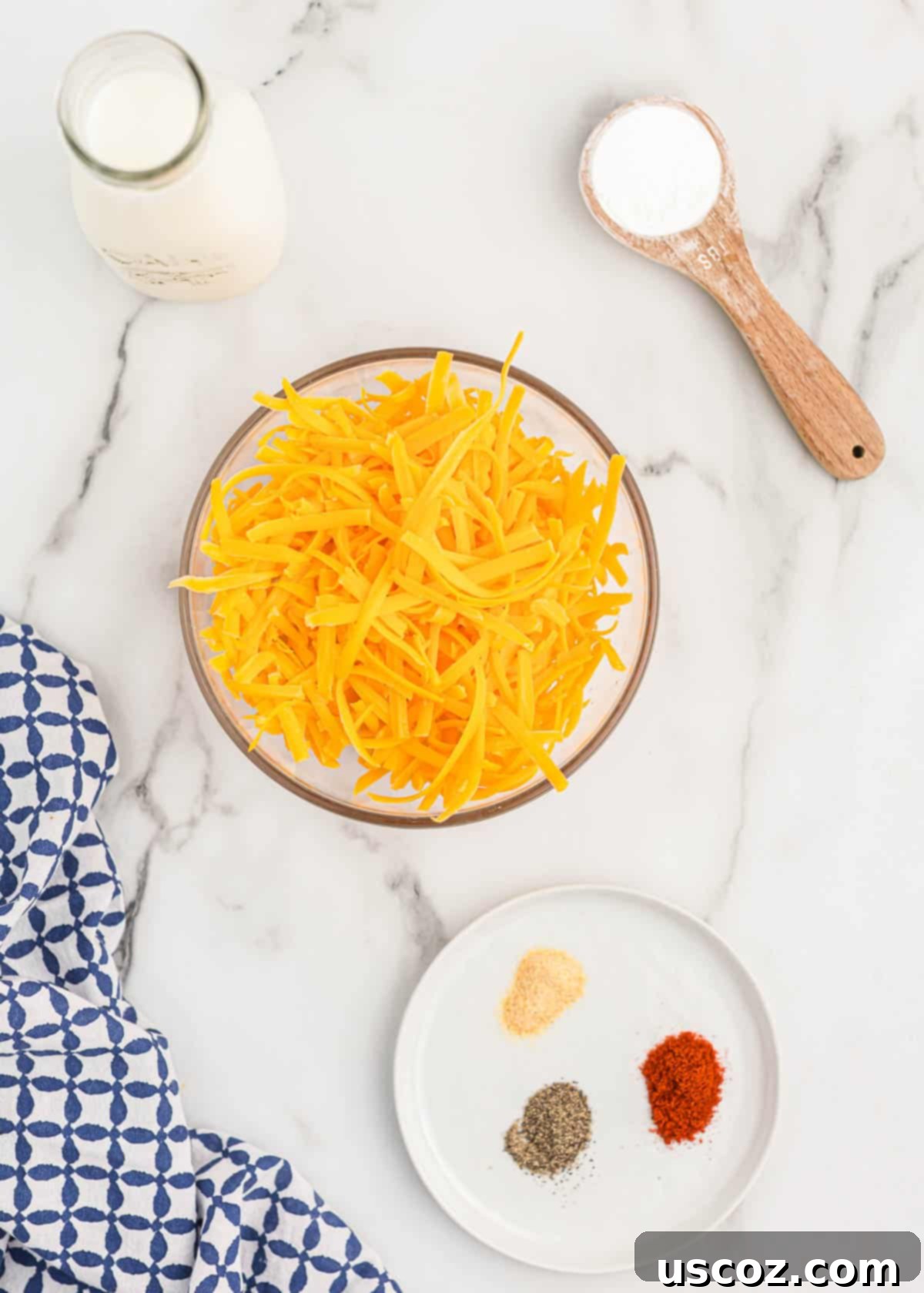 Ultimate Cheesy Broccoli Sauce 4 All the fresh ingredients laid out: block of cheddar cheese, milk, cornstarch, and spices