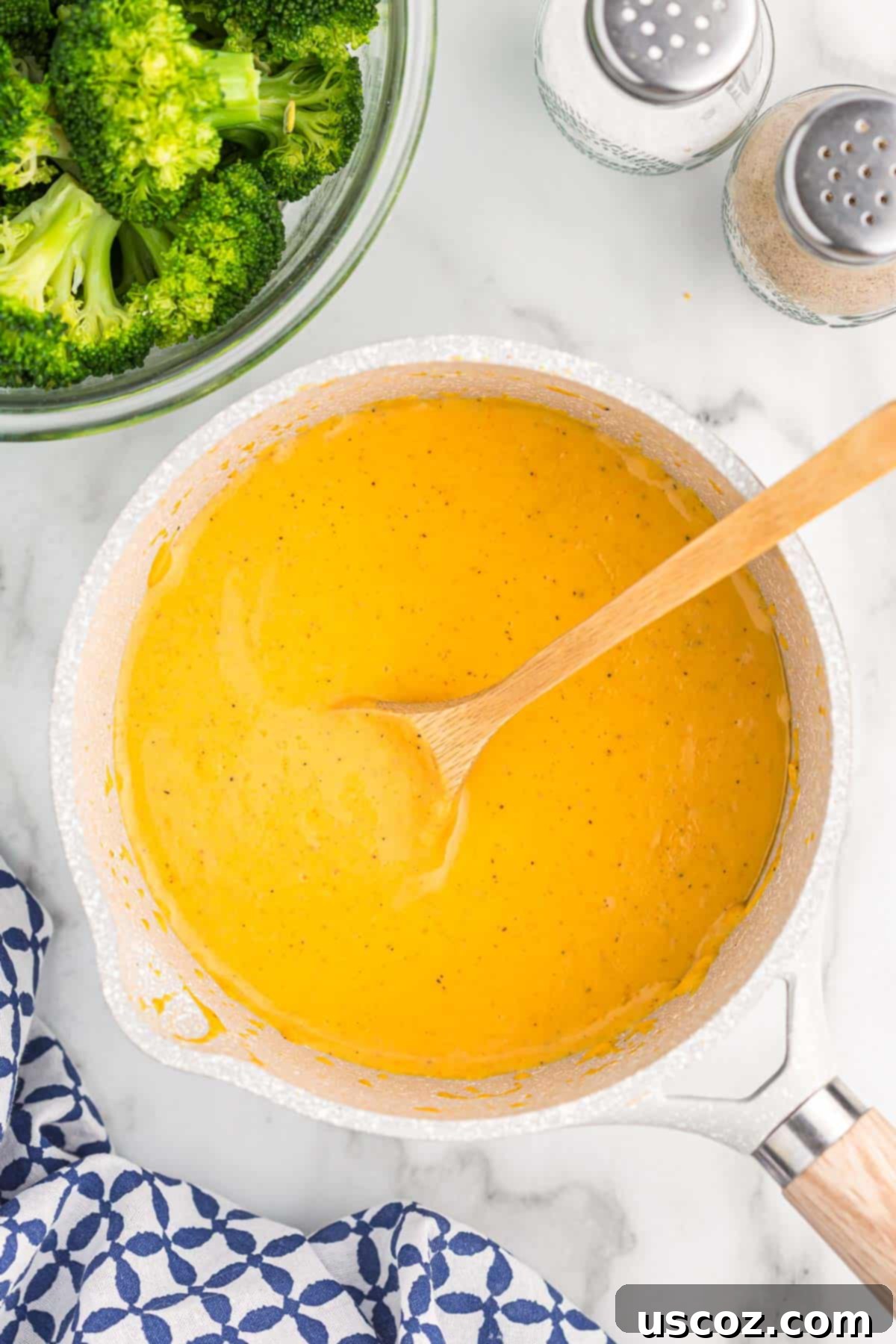 Ultimate Cheesy Broccoli Sauce 7 Close-up of cheese sauce simmering in a saucepan, showing its smooth texture
