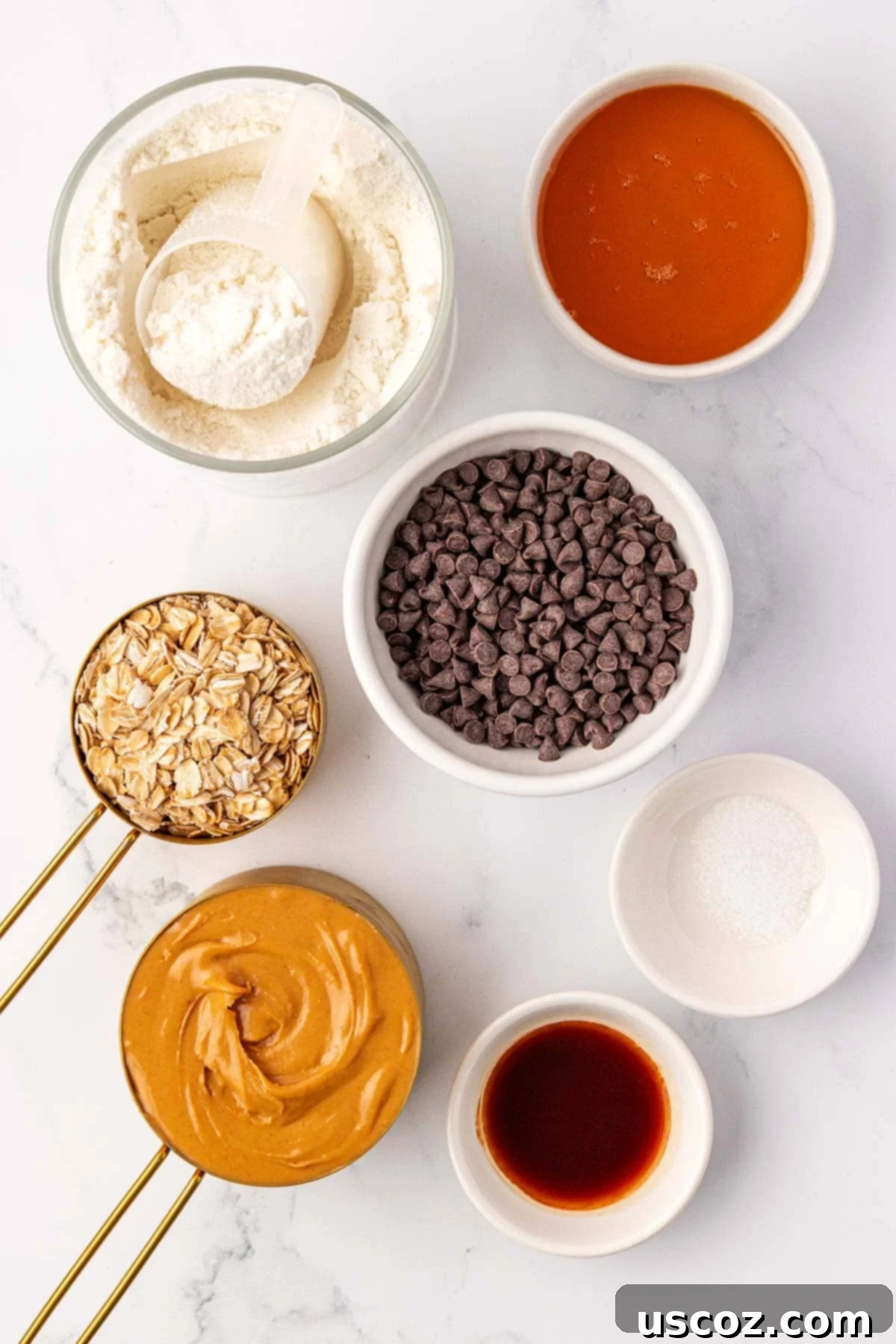 PB & Chocolate Chip Protein Bars 4 A flat lay image showing all the individual ingredients needed to make protein bars: peanut butter, honey, oats, protein powder, vanilla extract, salt, and mini chocolate chips.