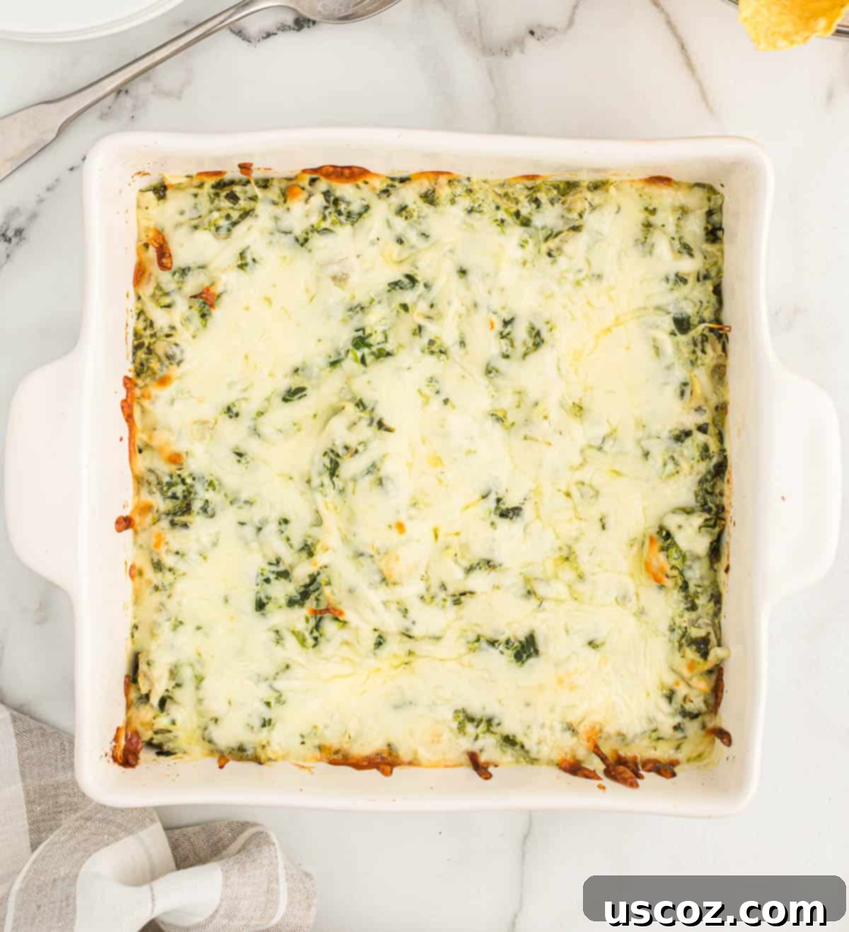 The Ultimate Baked Spinach Artichoke Dip 10 Baked spinach artichoke dip, freshly out of the oven, with a golden brown, bubbly cheese topping