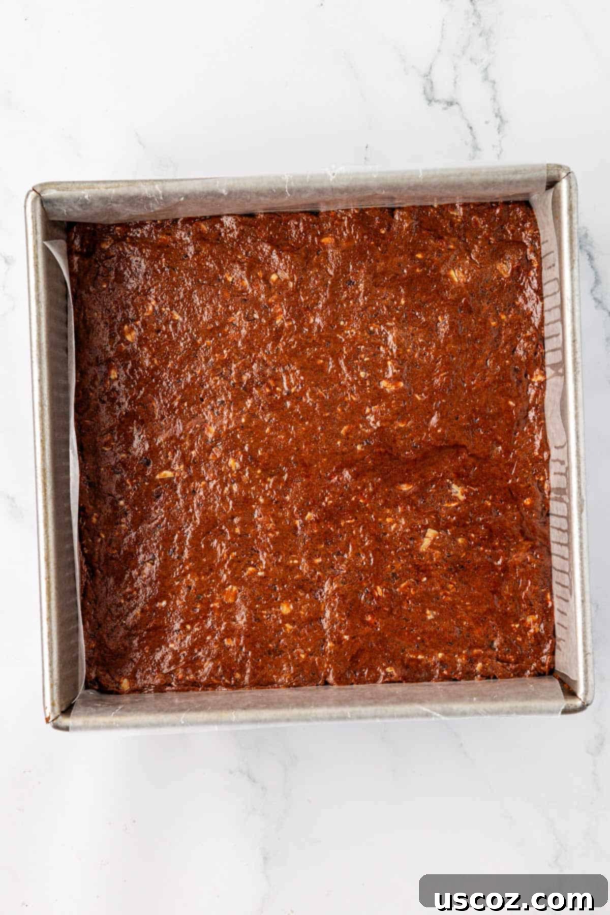 Chocolate Cashew Protein Bars 9 protein bar batter pressed into an 8 by 8 dish