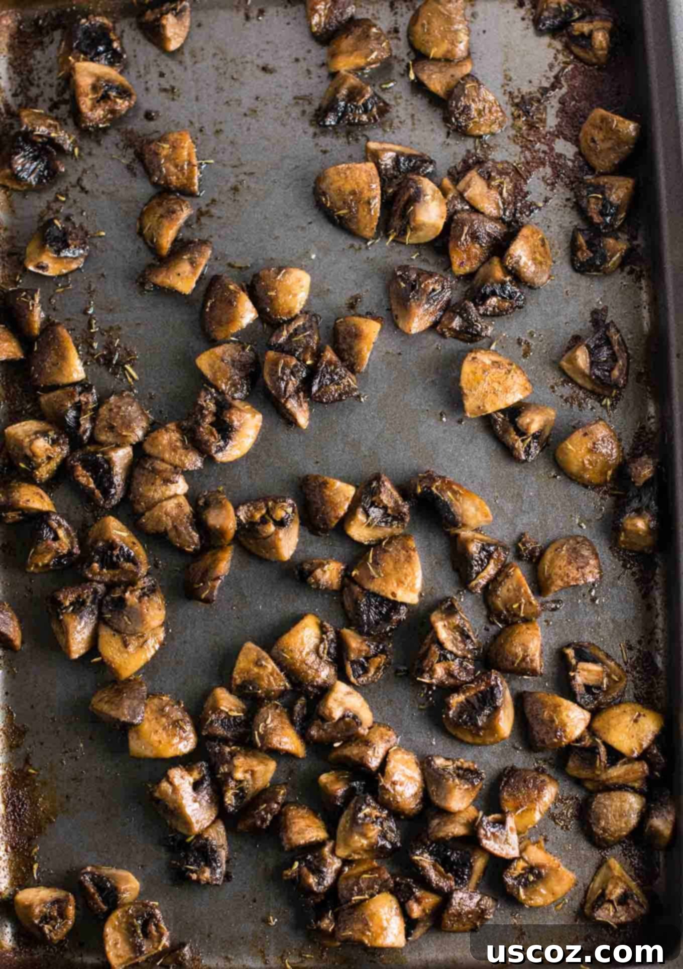No-Fuss Roasted Mushrooms 4 Mushroom quarters tossed with olive oil and spices in a bowl, ready for roasting.