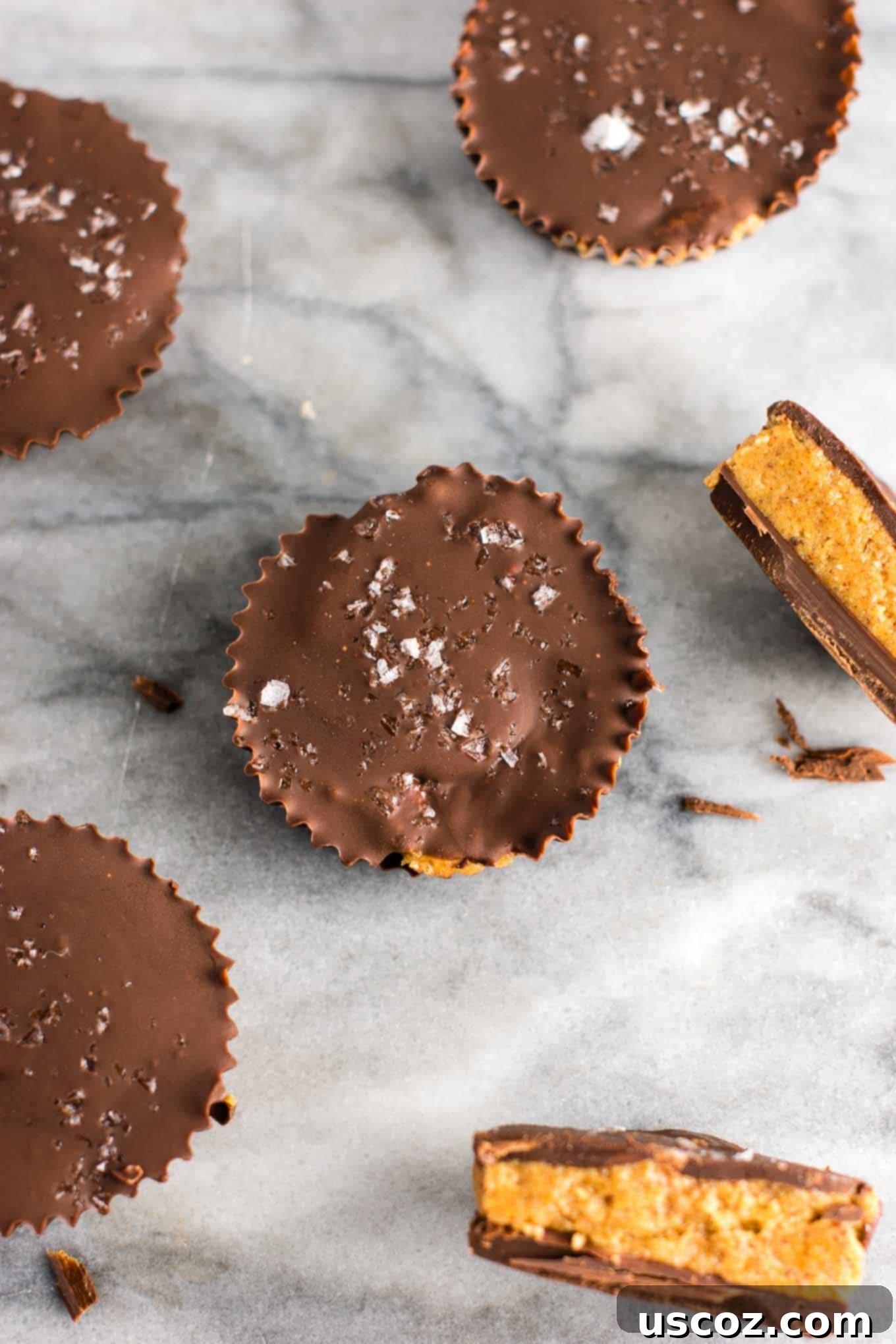 A tray of healthy almond butter cups topped with flaky sea salt, ready to be enjoyed