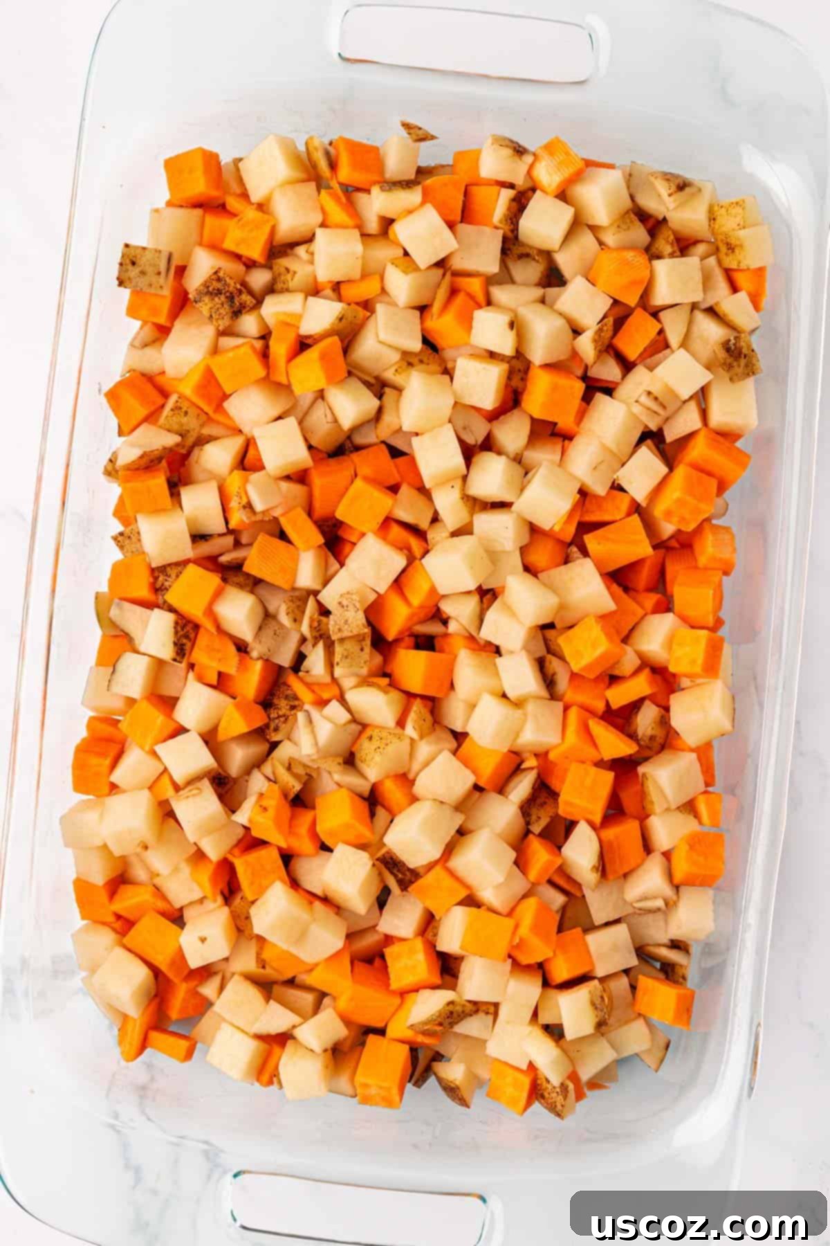 Hearty Vegan Breakfast Hash 5 Diced russet and sweet potatoes in a baking dish before seasoning