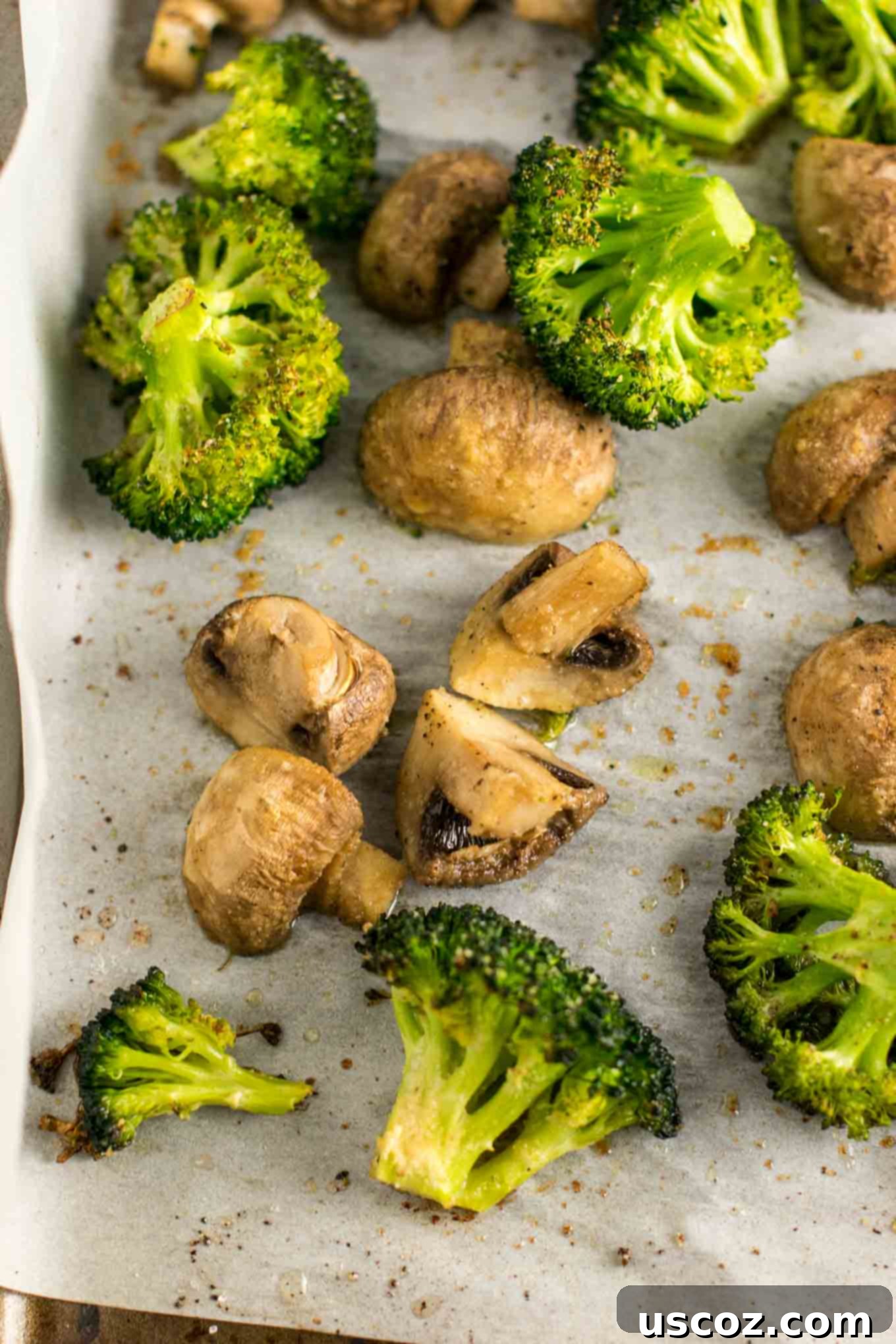Garlic Herb Roasted Broccoli and Mushrooms 7 Freshly roasted broccoli and mushrooms straight from the oven, offering a tempting view of their crispy edges and savory aroma
