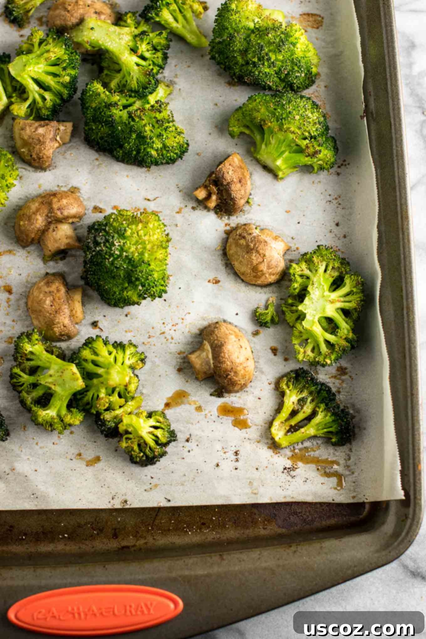 Garlic Herb Roasted Broccoli and Mushrooms 8 A large batch of roasted broccoli and mushrooms spread evenly on a baking sheet, ideal for meal prepping healthy vegetables
