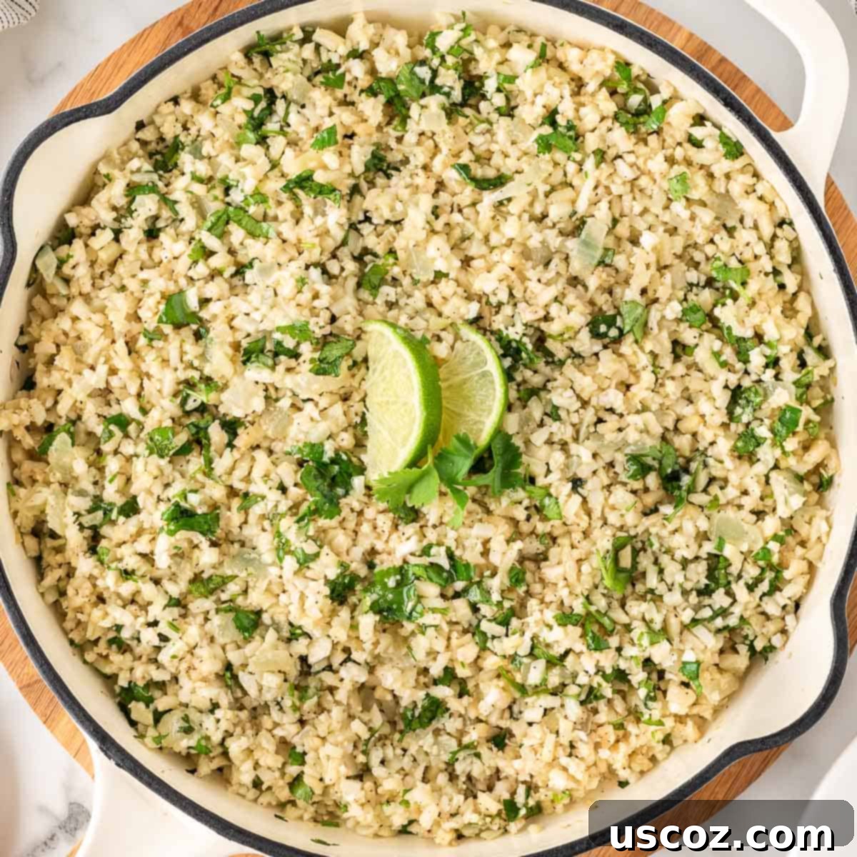 Plant-Powered Mexican Feasts 8 Freshly prepared cilantro lime cauliflower rice in a skillet, garnished with fresh cilantro