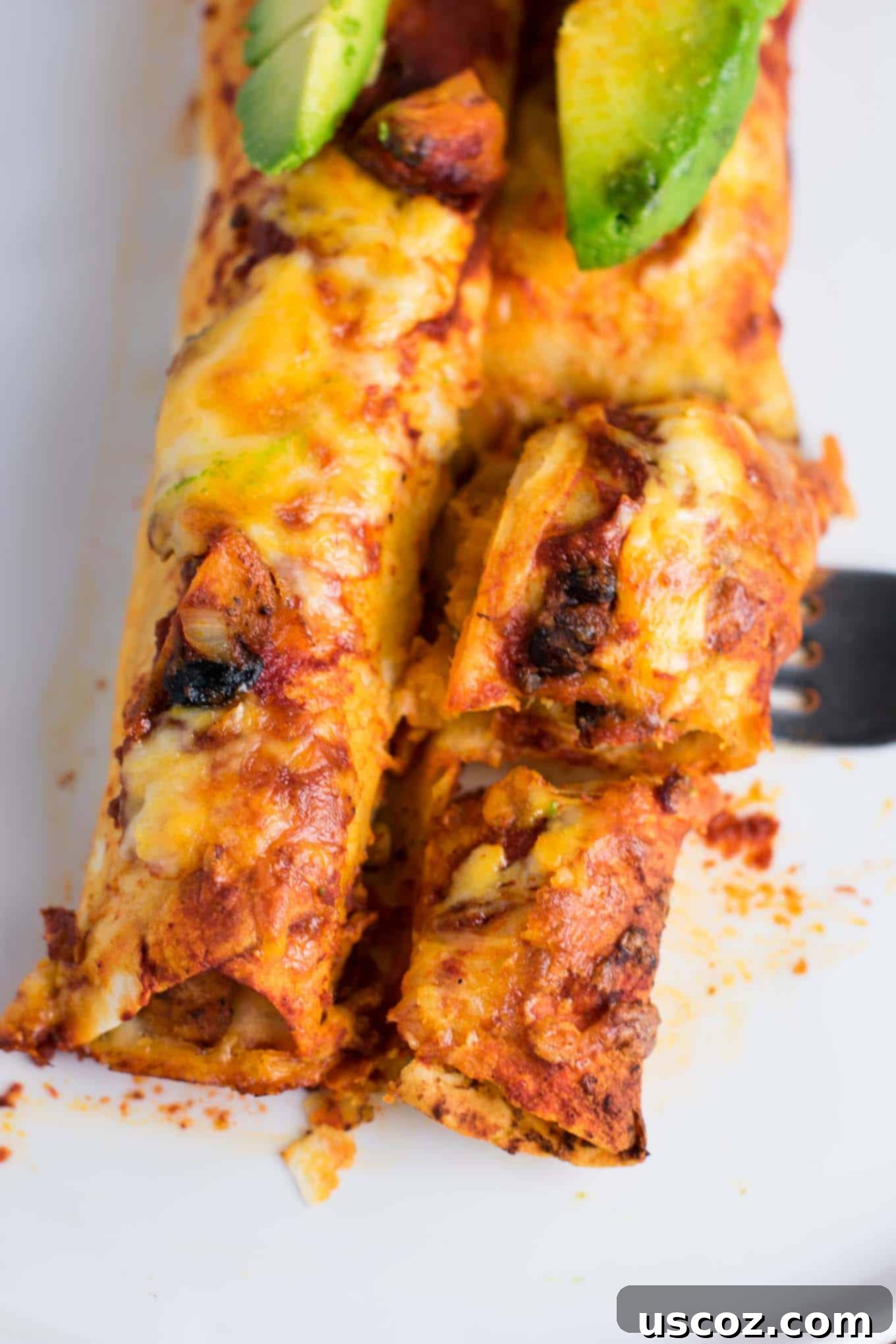 Plant-Powered Mexican Feasts 14 Smoky Sweet potato black bean enchiladas, topped with cheese and fresh cilantro, in a baking dish