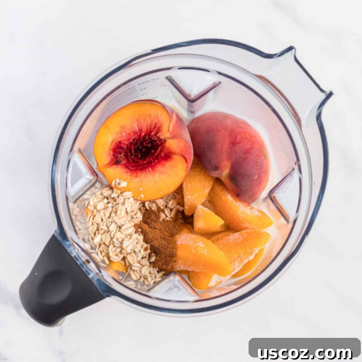 Wholesome Peach Smoothie 4 Close-up of all peach smoothie ingredients loaded into a high-speed blender, ready to be blended into a creamy drink.