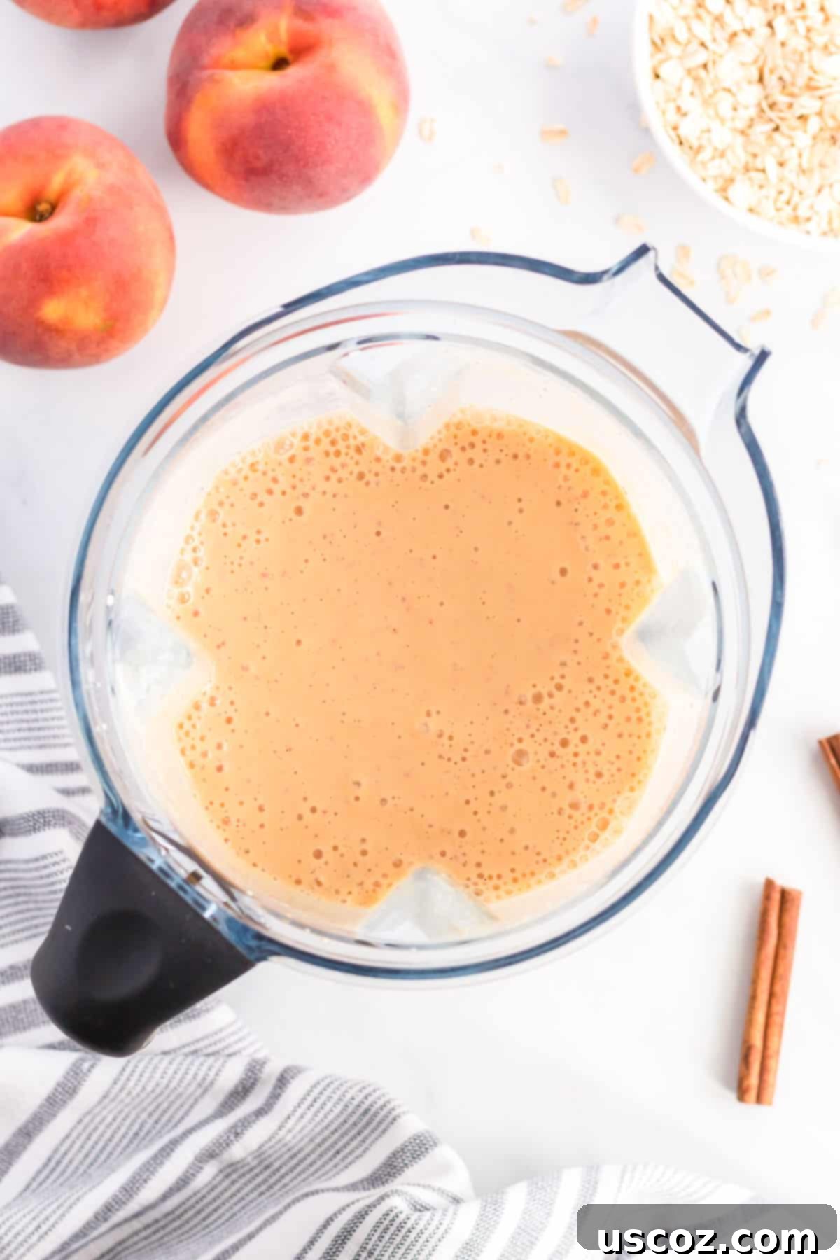 Wholesome Peach Smoothie 5 The peach smoothie blending in a high-speed blender, showing its thick and creamy consistency.