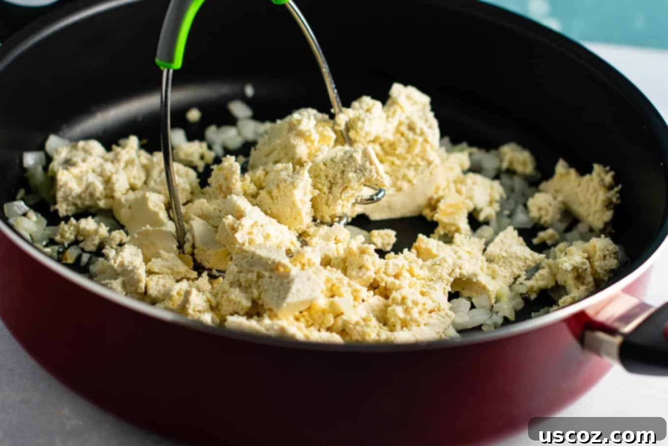 Wholesome Tofu Scramble 5 Close-up of crumbled tofu in a skillet, showcasing the desired egg-like texture before seasoning. #tofu #vegan #breakfast