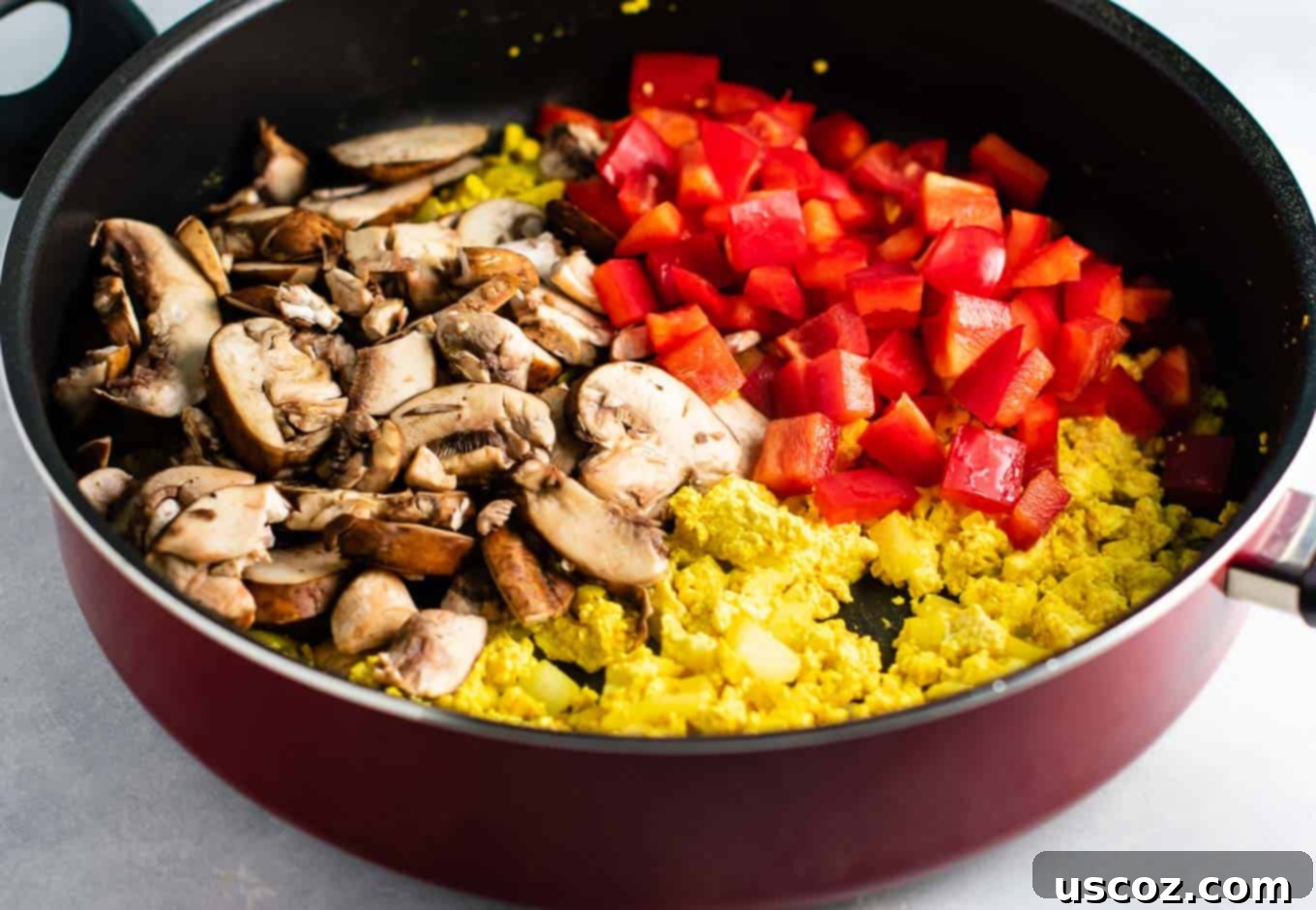 Wholesome Tofu Scramble 7 Adding sliced mushrooms and diced red bell peppers to the tofu scramble for extra flavor and nutrients. #veganfood #healthybreakfast