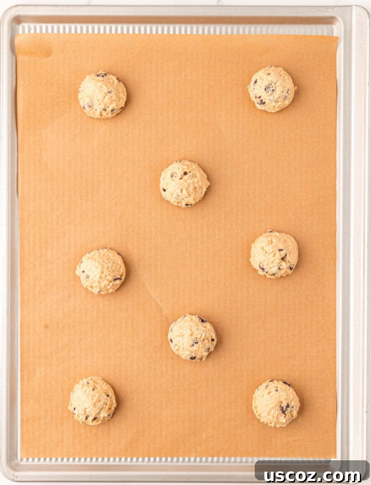 Delicious Vegan Chocolate Chip Cookies 13 cookie dough balls scooped onto a parchment-lined baking sheet