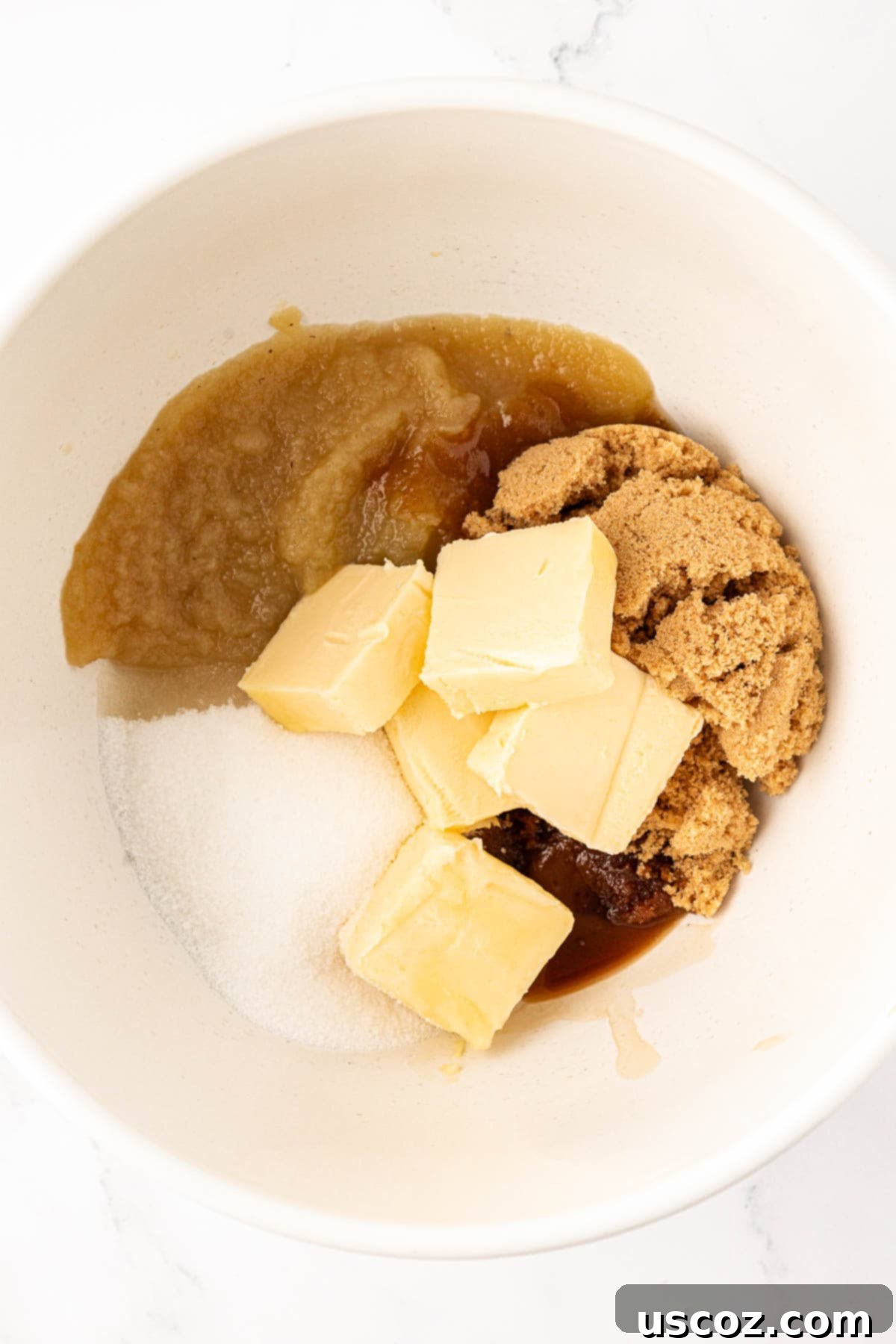 Delicious Vegan Chocolate Chip Cookies 7 wet ingredients (sugars, applesauce, vegan butter, vanilla extract) in a mixing bowl before combining