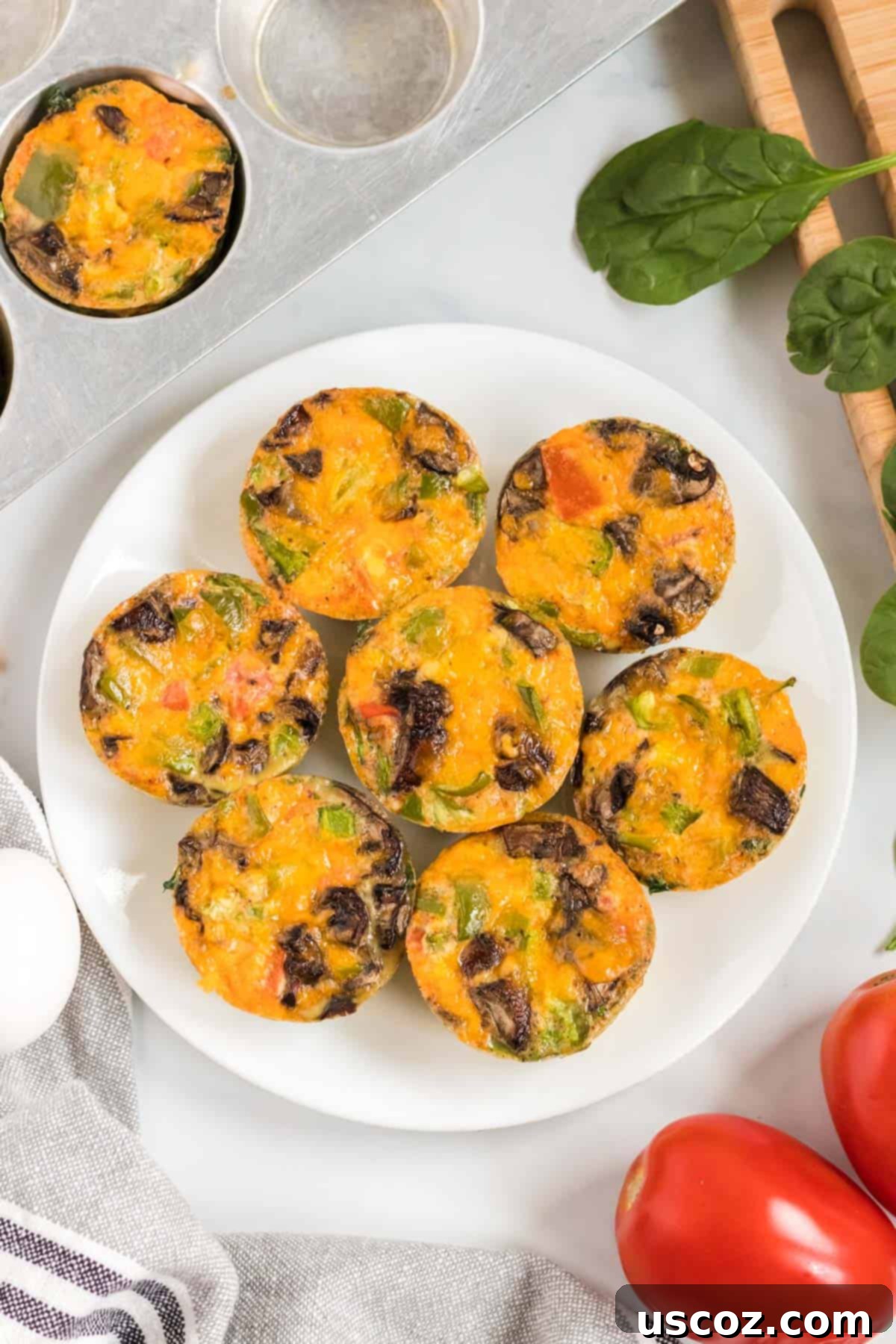 Savory Egg Muffins 2 Delicious egg muffin cups served on a white plate, ready for a healthy breakfast.