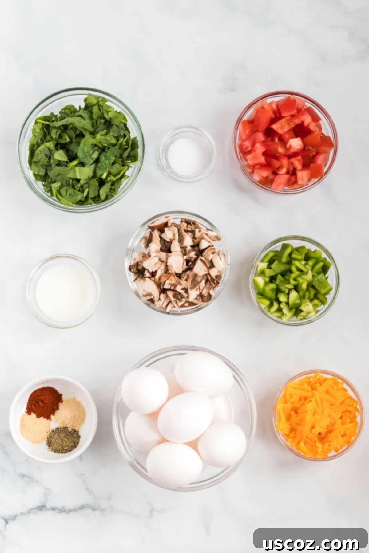 Savory Egg Muffins 4 A vibrant selection of fresh ingredients including eggs, chopped vegetables, milk, and cheese, ready for making egg muffin cups.
