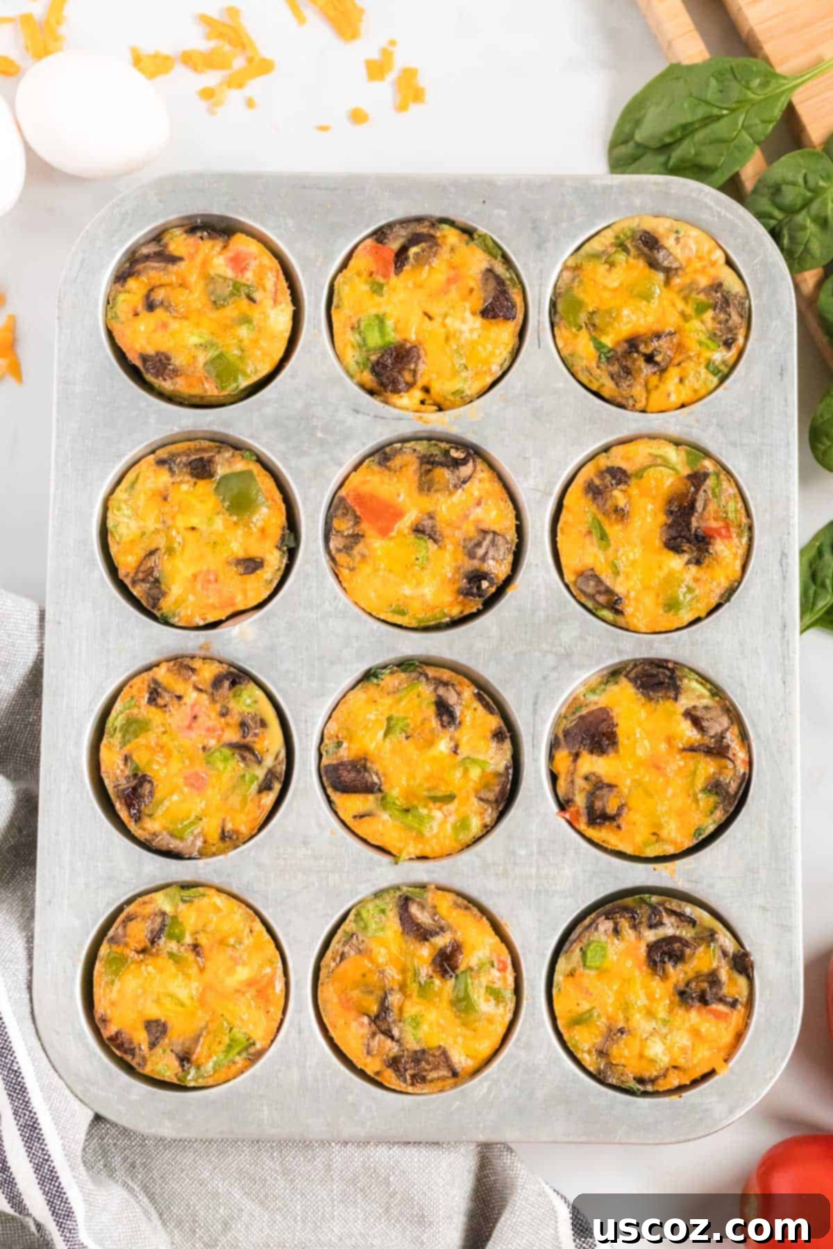 Savory Egg Muffins 7 A muffin tin filled with freshly baked, golden-brown egg muffins, perfectly cooked and ready to be removed.