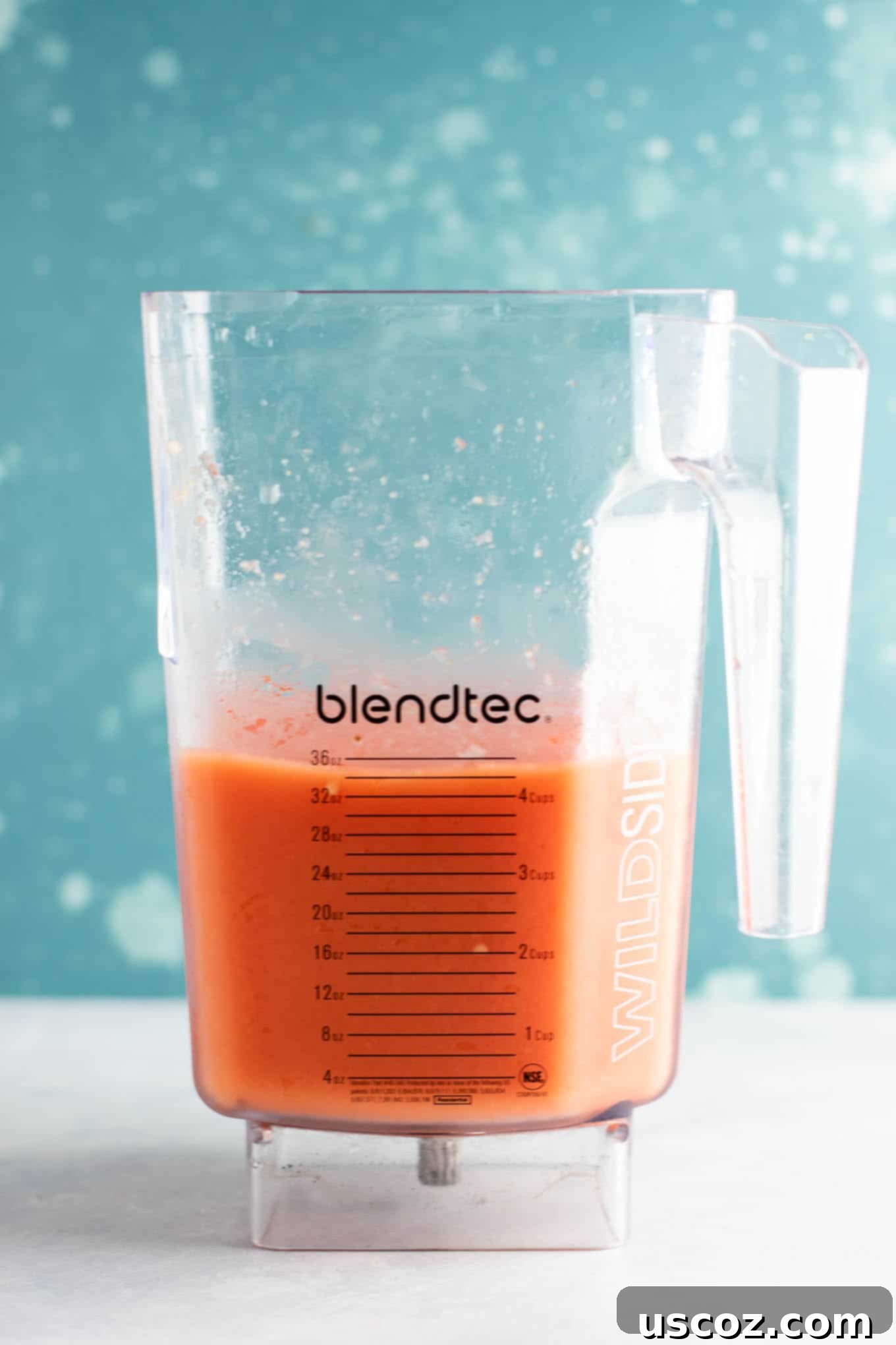 Blended watermelon, mango, and peach gin slushie ready to be served