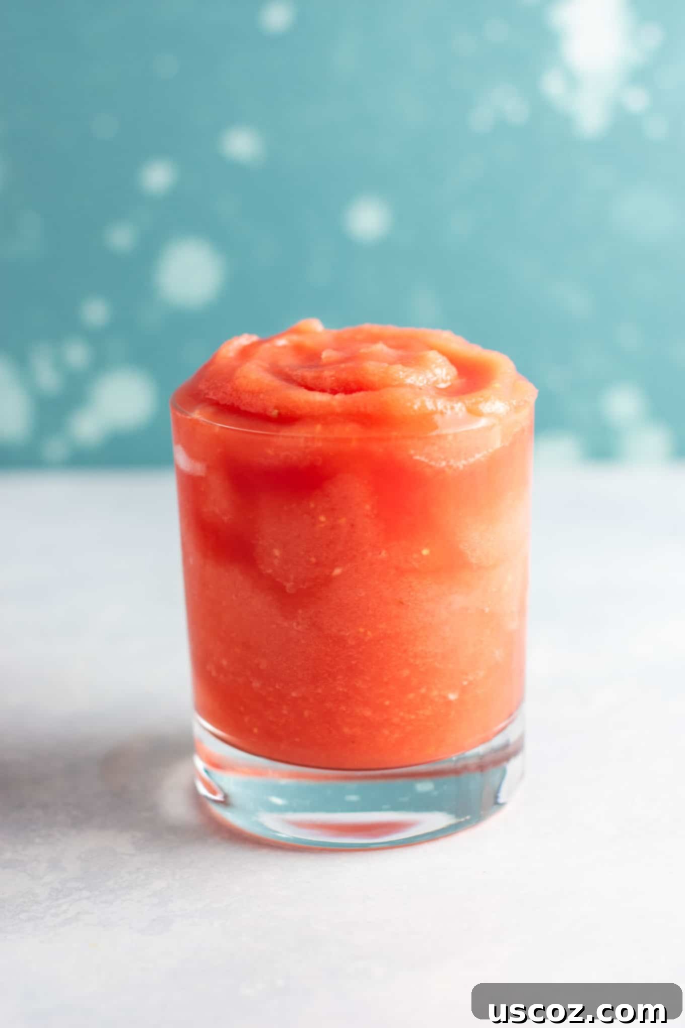 Watermelon gin cocktail with lime slices and fresh mint garnish