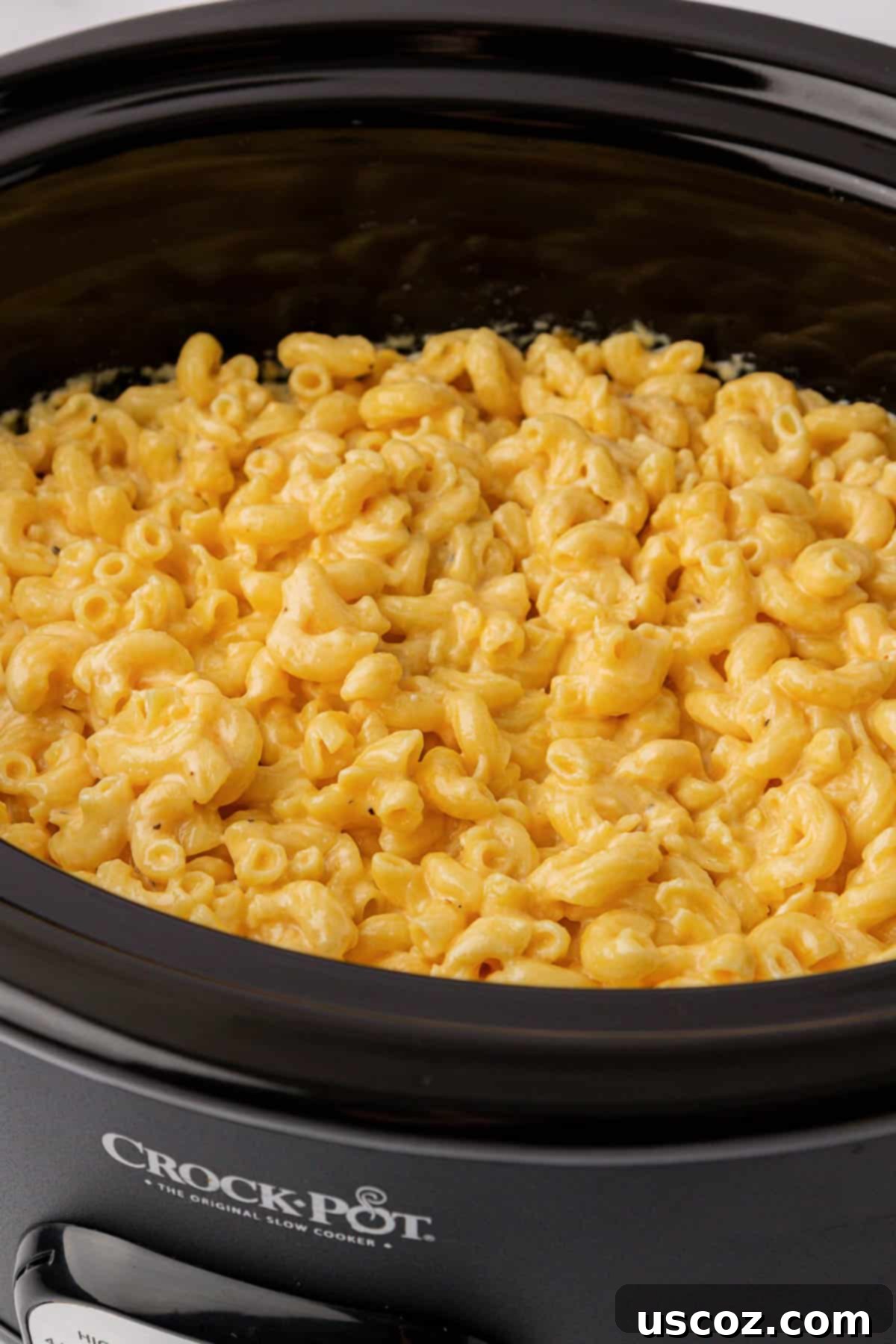 Crock Pot Pasta: Does It Actually Work? 7 Delicious macaroni and cheese cooking in a crock pot, perfect for a comfort meal.
