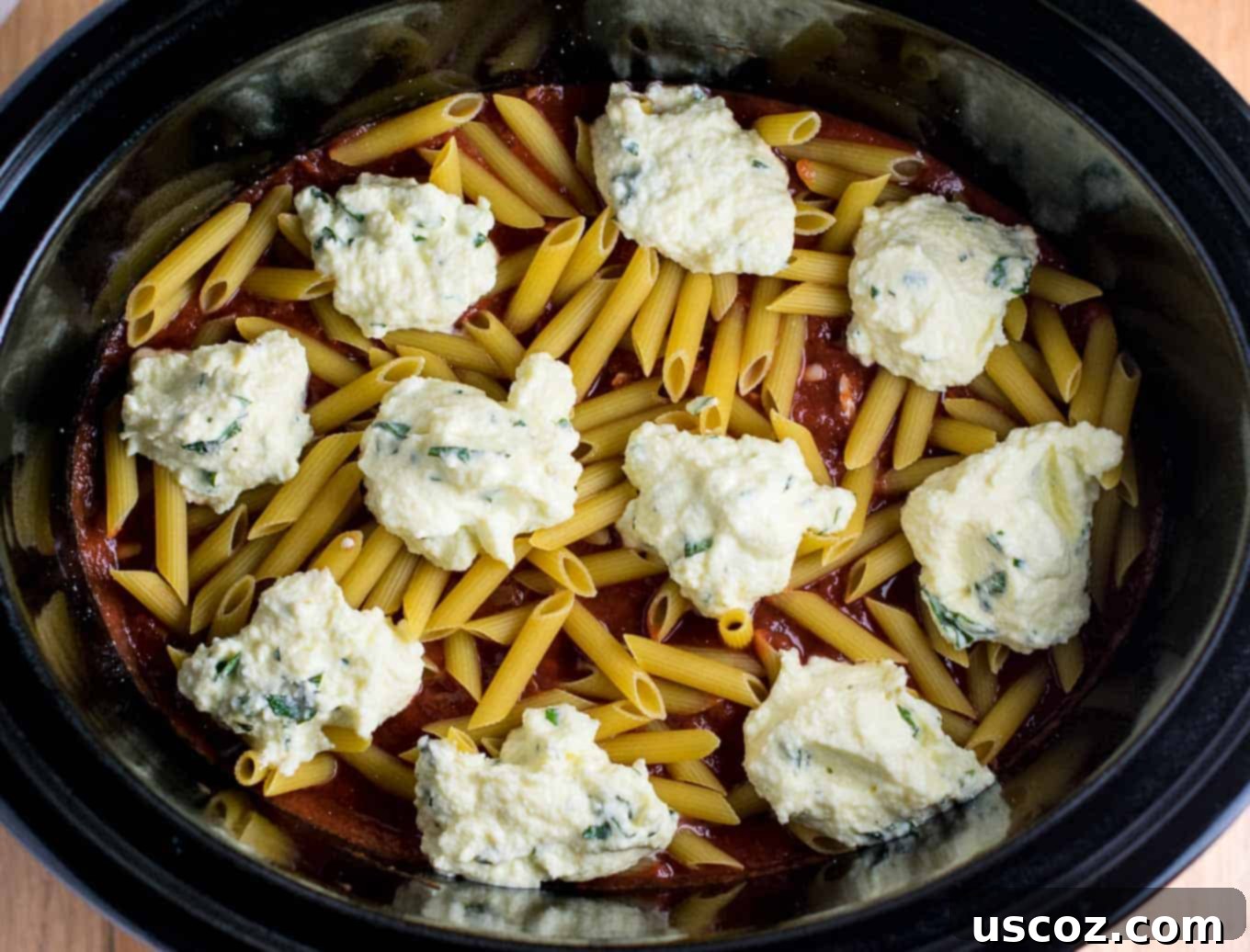 Crock Pot Pasta: Does It Actually Work? 8 Easy Crock pot Baked Ziti recipe showing delicious layers of pasta and sauce.