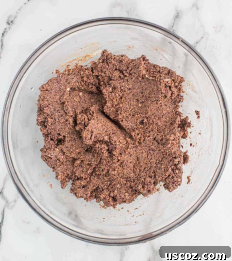 Ultimate Black Bean Burgers 7 well-combined black bean burger mixture in a mixing bowl, ready for shaping