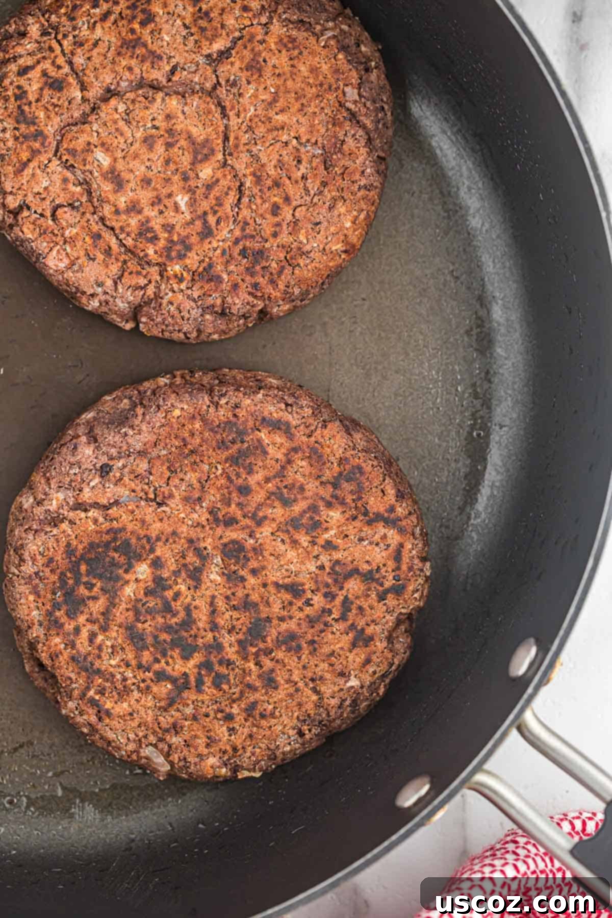 Ultimate Black Bean Burgers 9 golden-brown and crispy cooked black bean burgers sizzling in a skillet