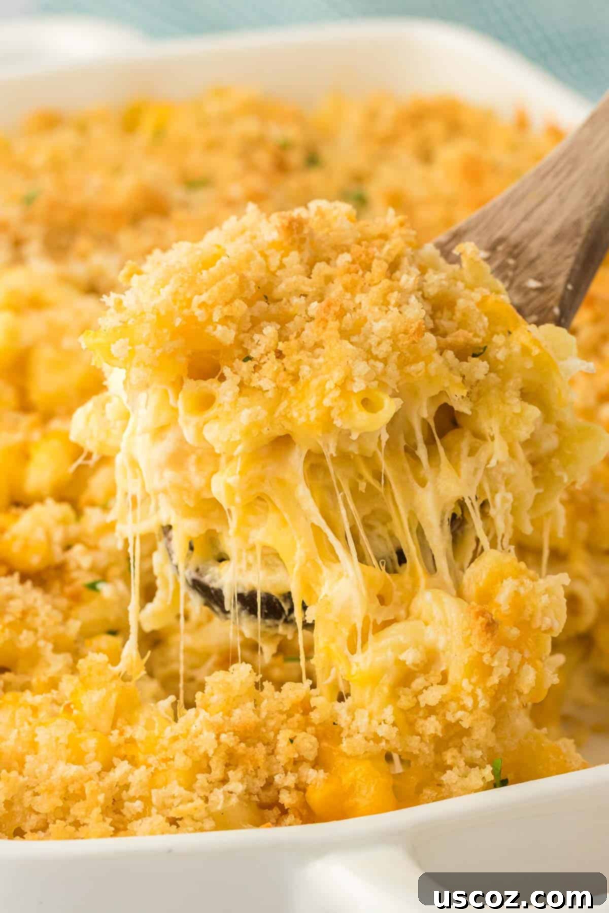 Golden Baked Macaroni Perfection 21 scooping mac and cheese from the baking dish