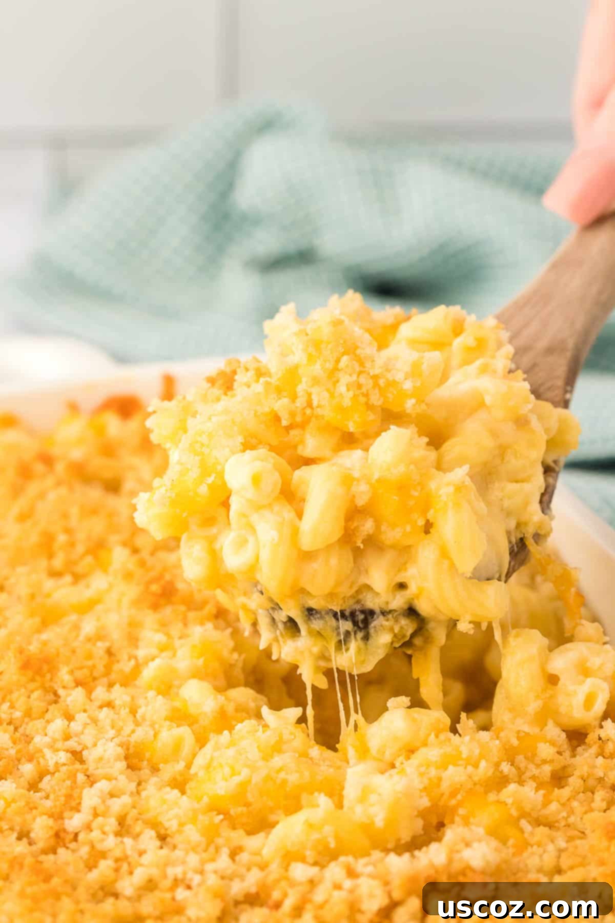 Golden Baked Macaroni Perfection 23 scooping mac and cheese from the baking dish