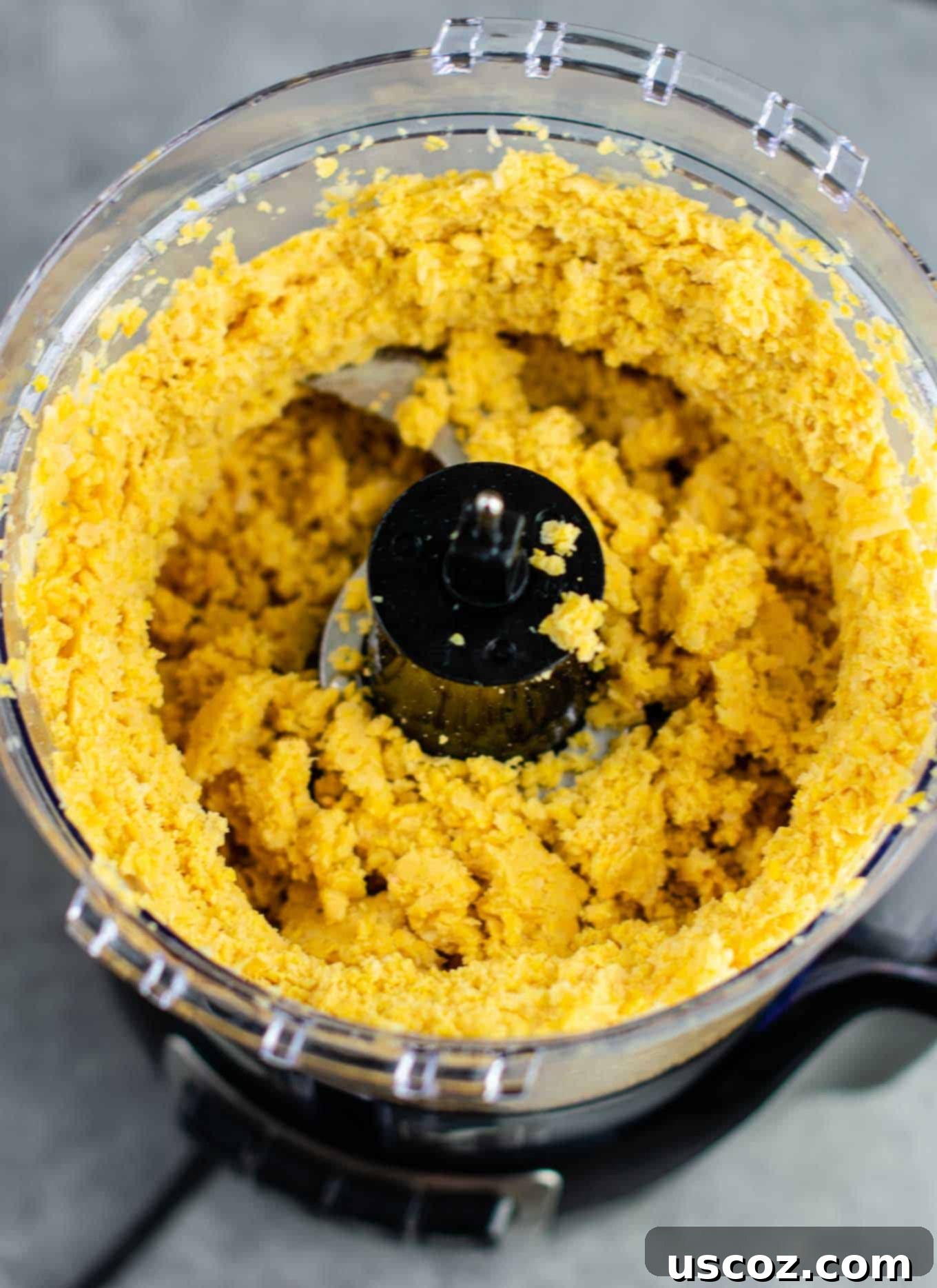 Golden Chickpea Poppers 5 Processed chickpeas in a food processor, showing a flaky, crumbly consistency suitable for forming nuggets.