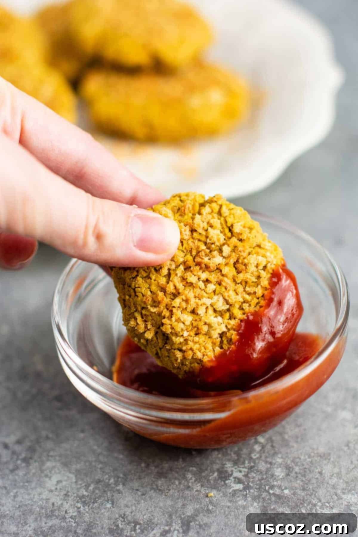Golden Chickpea Poppers 6 Baked vegetarian chickpea nuggets arranged neatly on a baking sheet, golden and crispy, ready for dipping.