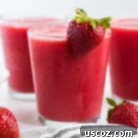 Sweet Summer Smoothie Sensation 9 strawberry watermelon smoothie in a glass with a strawberry on the rim