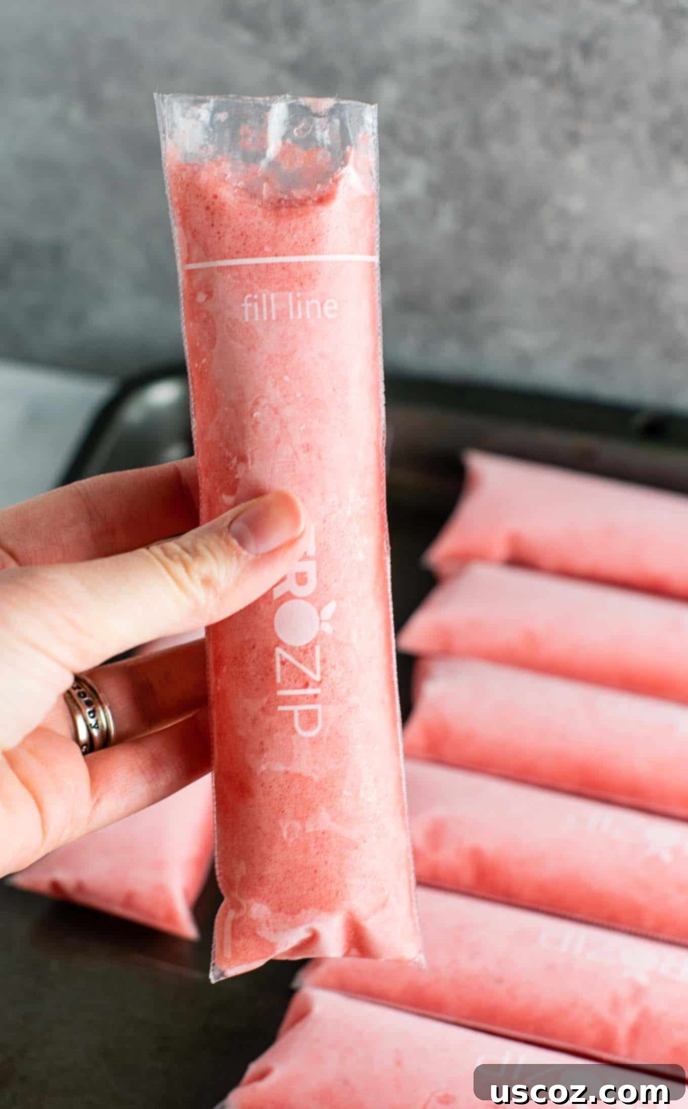 A collection of homemade Strawberry Pineapple Freezer Pops, vibrant and ready to freeze, emphasizing the ease of making healthy ice pops at home.