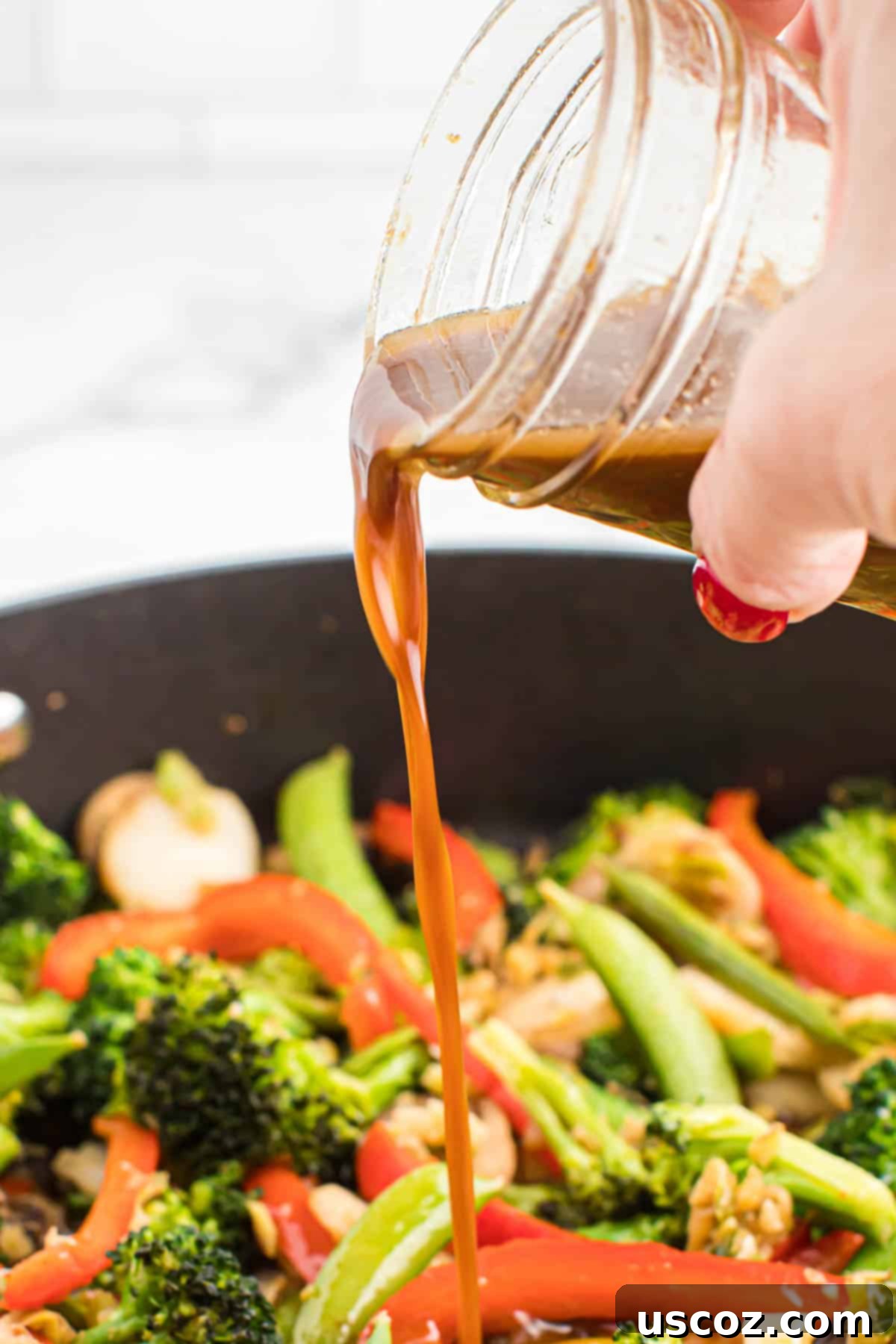 Quick Vegetable Stir Fry 12 pouring stir fry sauce over vegetables
