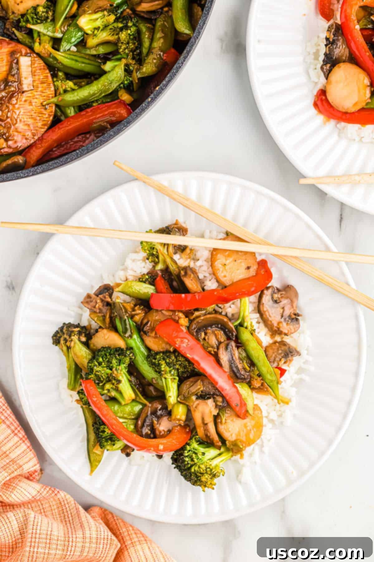 Quick Vegetable Stir Fry 5 veggie stir fry over white rice on a plate with chopsticks