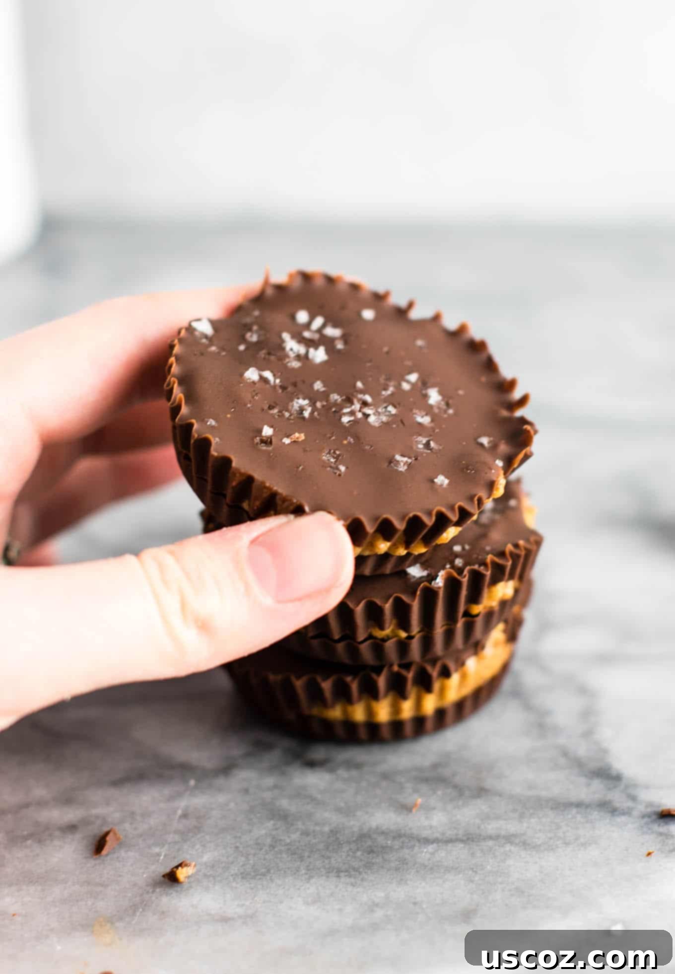25 Decadent Gluten-Free Dairy-Free Desserts 16 Gourmet almond butter cups with a sprinkle of flaky sea salt on top, showing their rich chocolate coating.