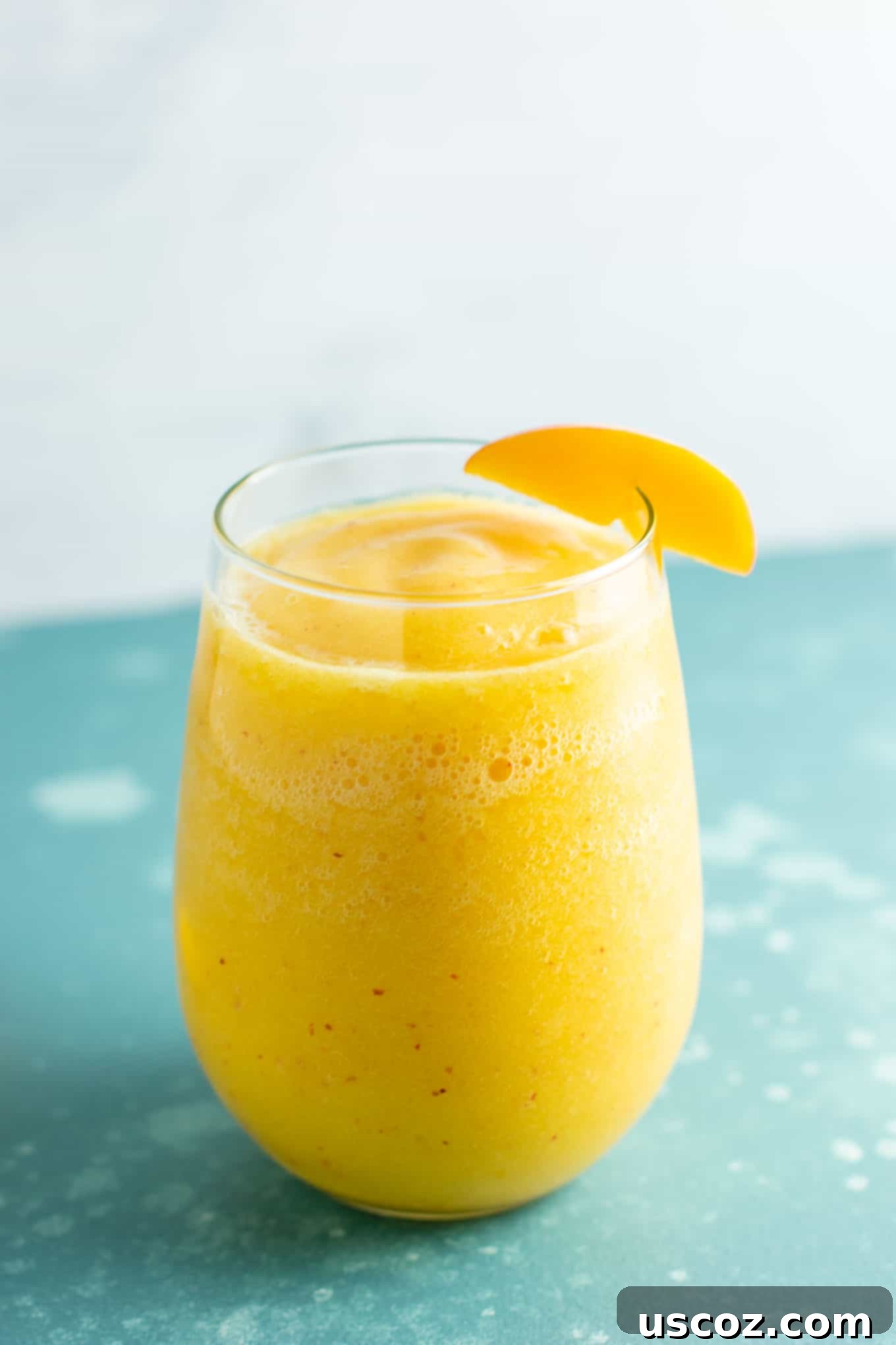 A close-up shot of a peach moscato slushie, highlighting its refreshing texture, perfect for a healthy and delicious summer drink.