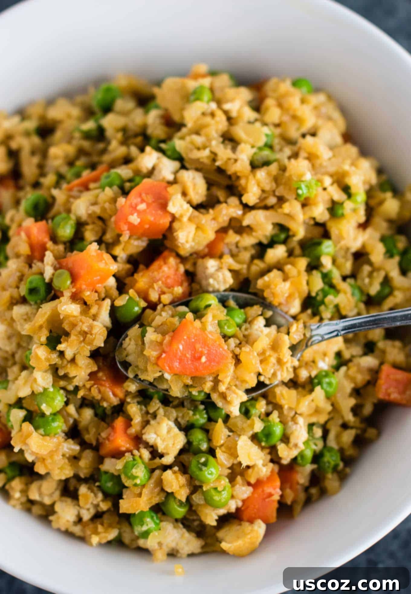 Unlock 29 Delicious Vegan Dinners 9 Cauliflower Tofu Fried Rice, a vegan, gluten-free, grain-free, and low-carb fried rice alternative without eggs.