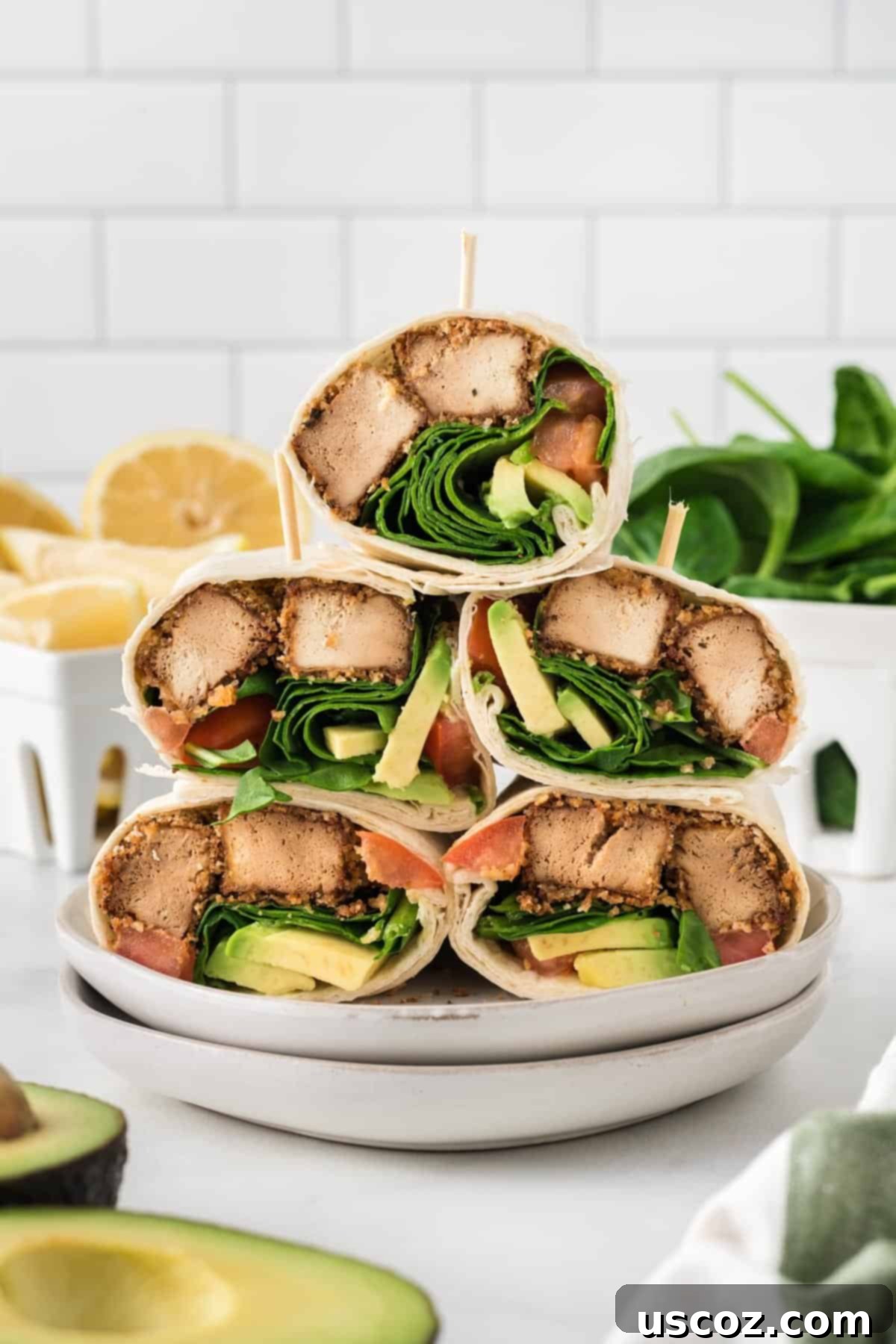 Unlock 29 Delicious Vegan Dinners 10 Crispy tofu wraps stacked on a plate with fresh veggies, a flavorful and easy vegan meal.
